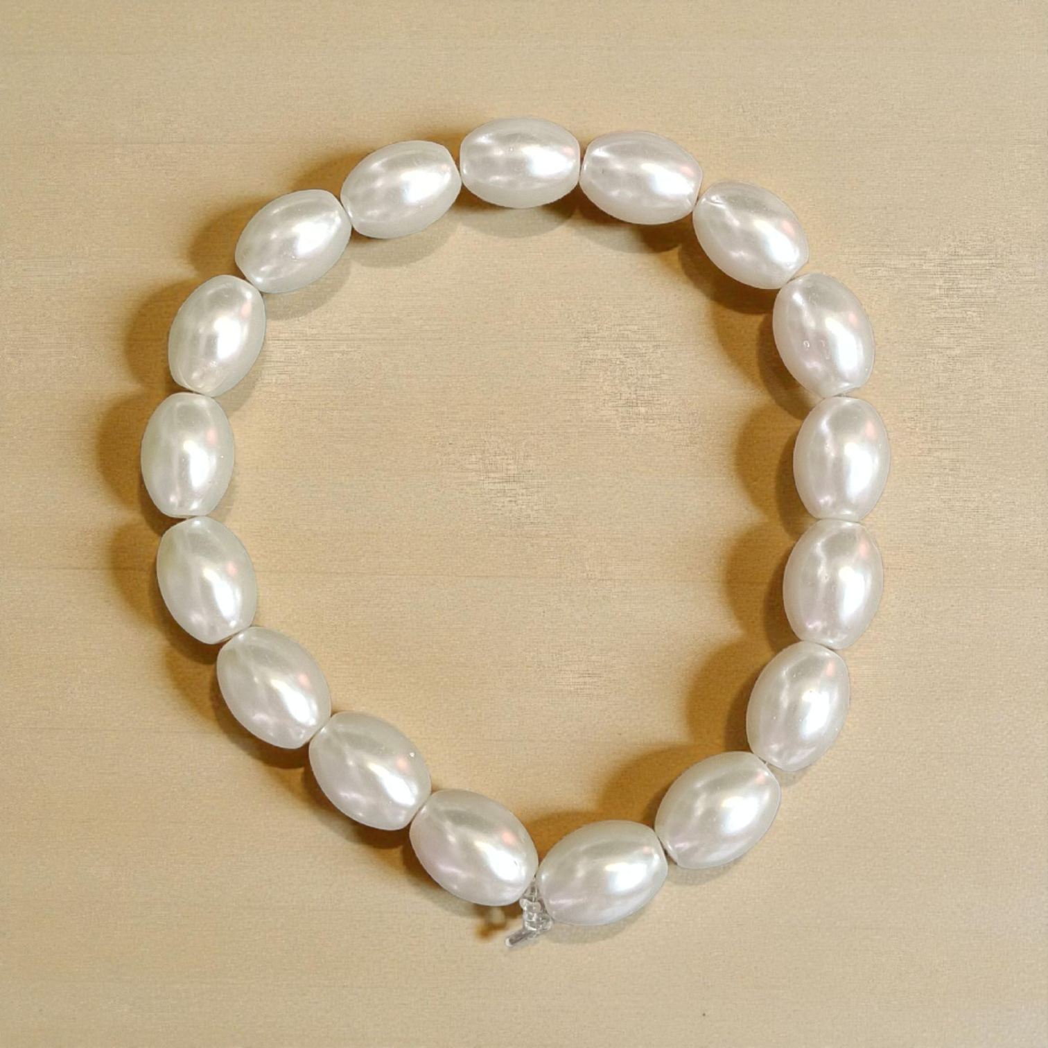 Natural Pearl Bracelet (Moti Mala) with 10–11mm round white beads, displayed on a velvet background, symbolizing peace and emotional balance