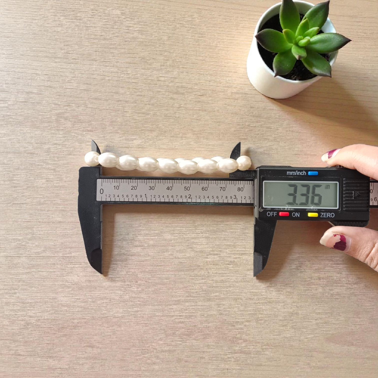 Natural Pearl Bracelet (Moti Mala) with 10–11mm round white beads, displayed on a velvet background, symbolizing peace and emotional balance