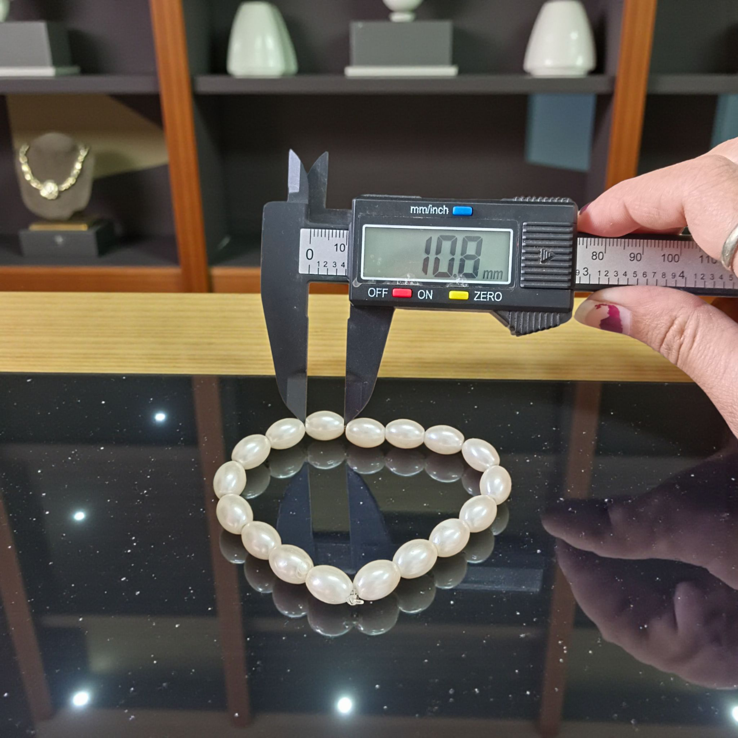 Natural Pearl Bracelet (Moti Mala) with 10–11mm round white beads, displayed on a velvet background, symbolizing peace and emotional balance