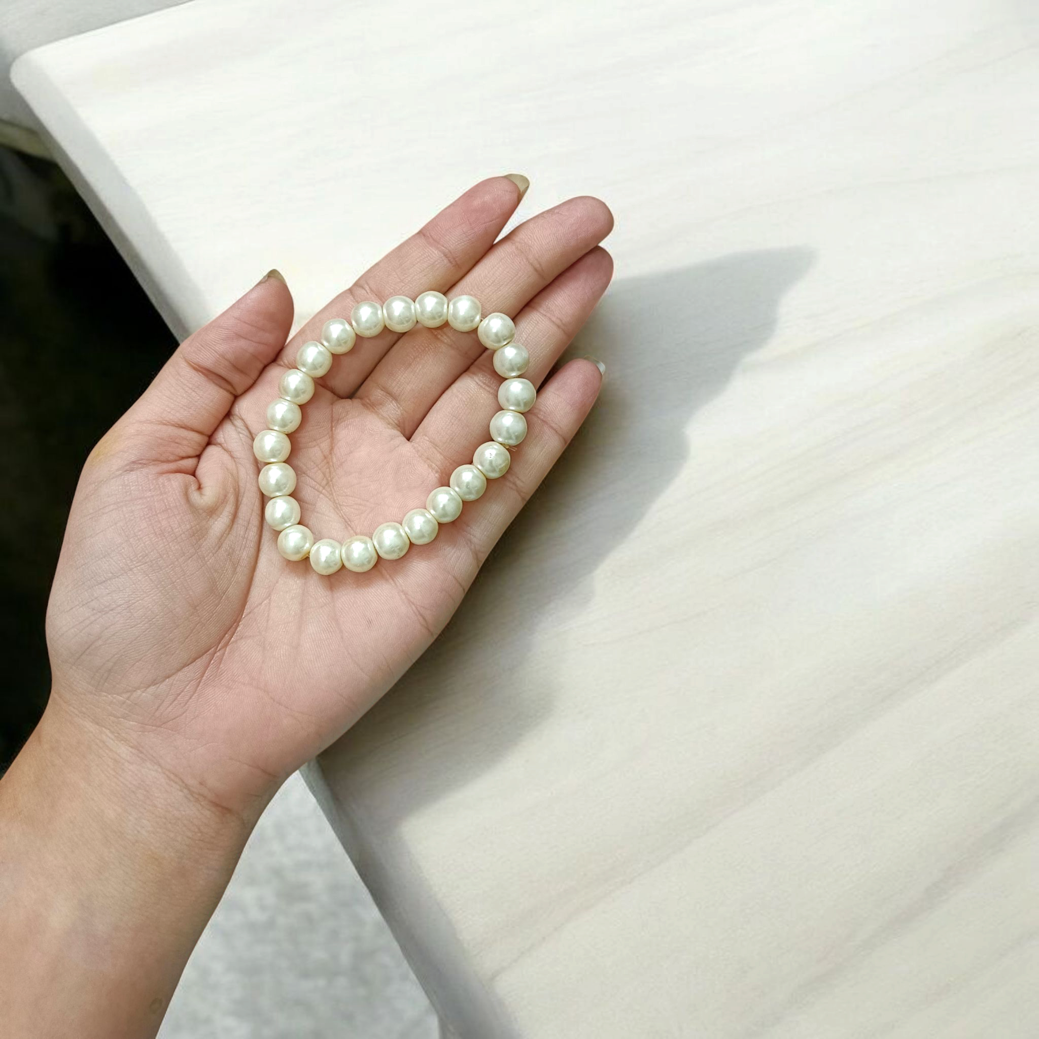 Natural Pearl Bracelet with 8mm round white pearls, stretchable design, perfect for men and women, displayed on a clean background