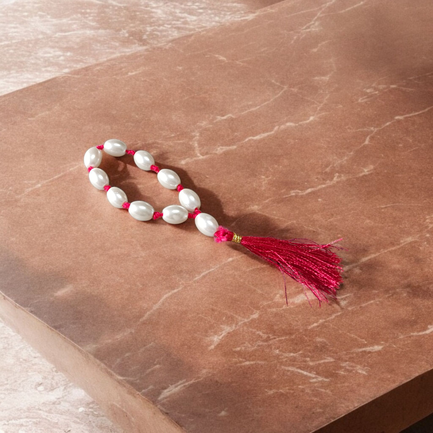 Natural Pearl Finger Mala with 9+1 round white pearls (10–11mm) displayed on a soft background, ideal for chanting and meditation