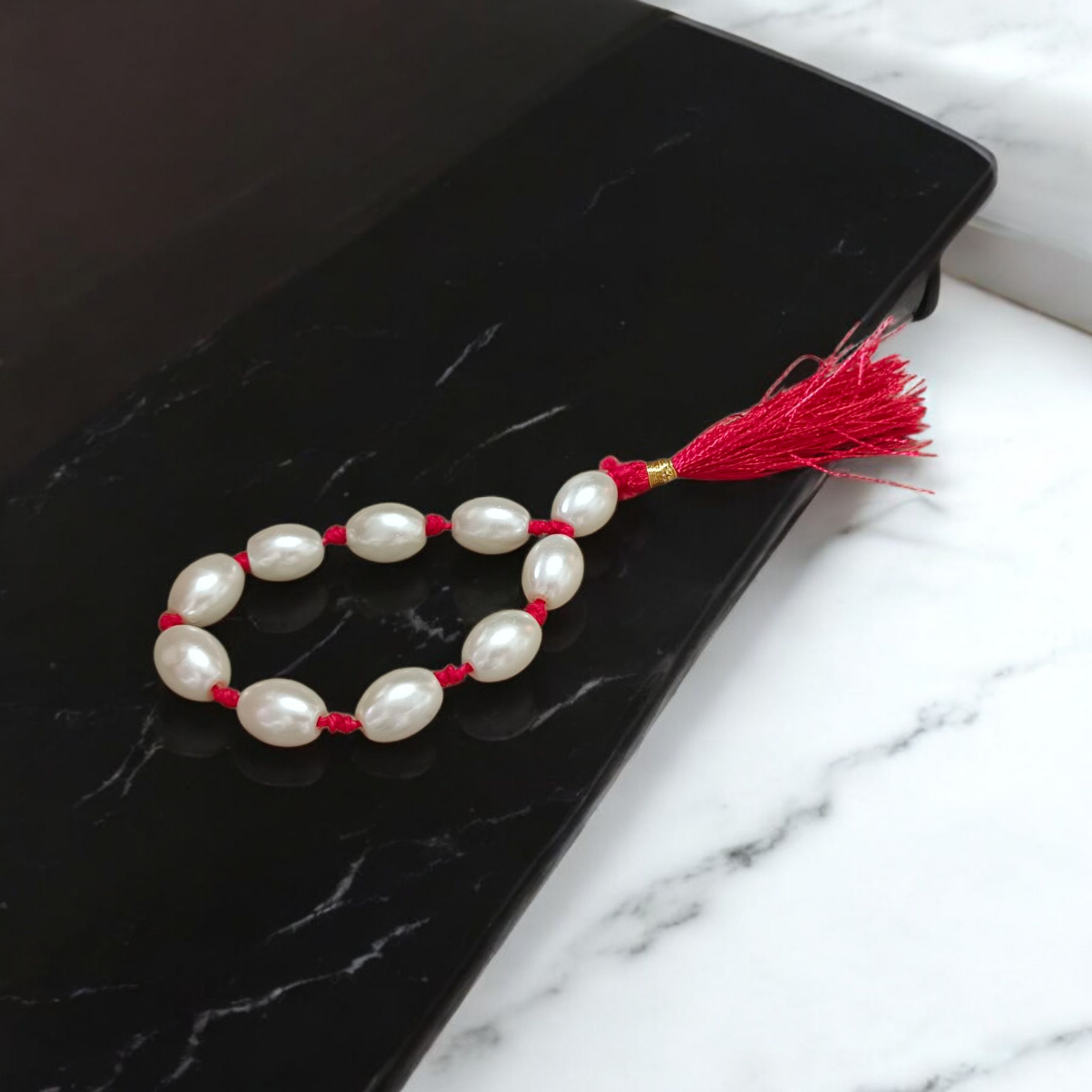 Natural Pearl Finger Mala with 9+1 round white pearls (10–11mm) displayed on a soft background, ideal for chanting and meditation
