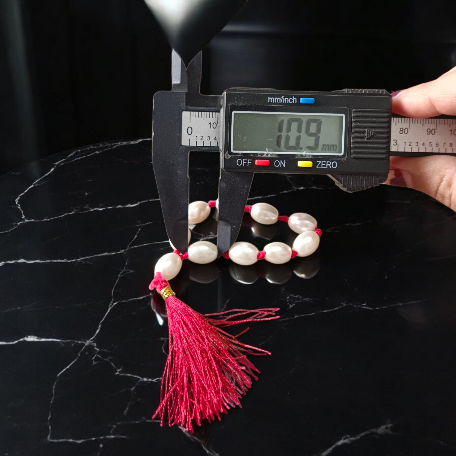 Natural Pearl Finger Mala with 9+1 round white pearls (10–11mm) displayed on a soft background, ideal for chanting and meditation