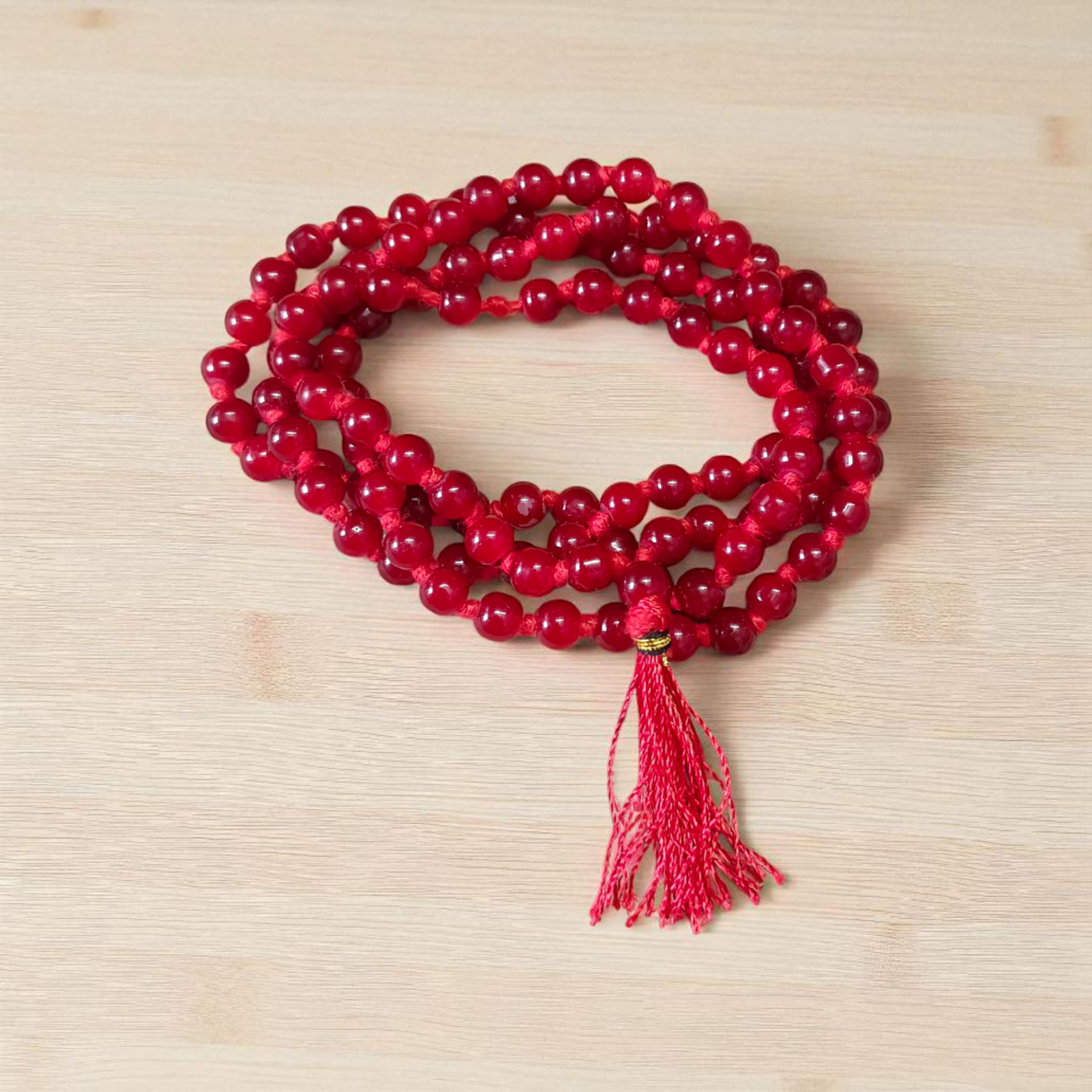 Natural Red Agate Mala with 108+1 round 6mm beads, ideal for mantra chanting and spiritual wear, shown with vibrant red stones and a guru bead