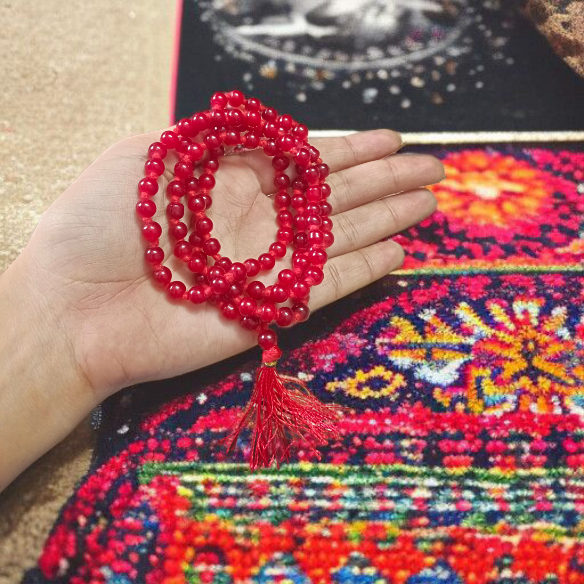Natural Red Agate Mala with 108+1 round 6mm beads, ideal for mantra chanting and spiritual wear, shown with vibrant red stones and a guru bead