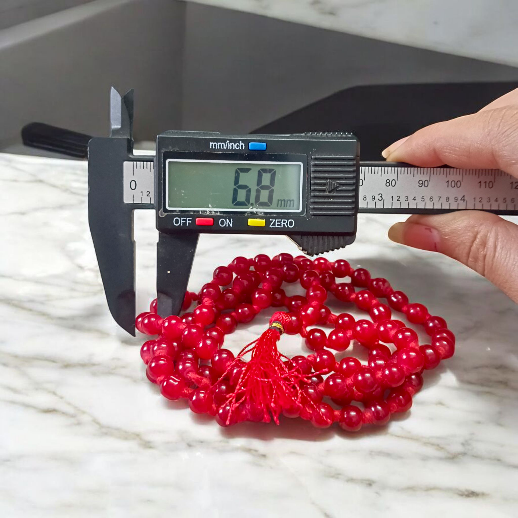 Natural Red Agate Mala with 108+1 round 6mm beads, ideal for mantra chanting and spiritual wear, shown with vibrant red stones and a guru bead