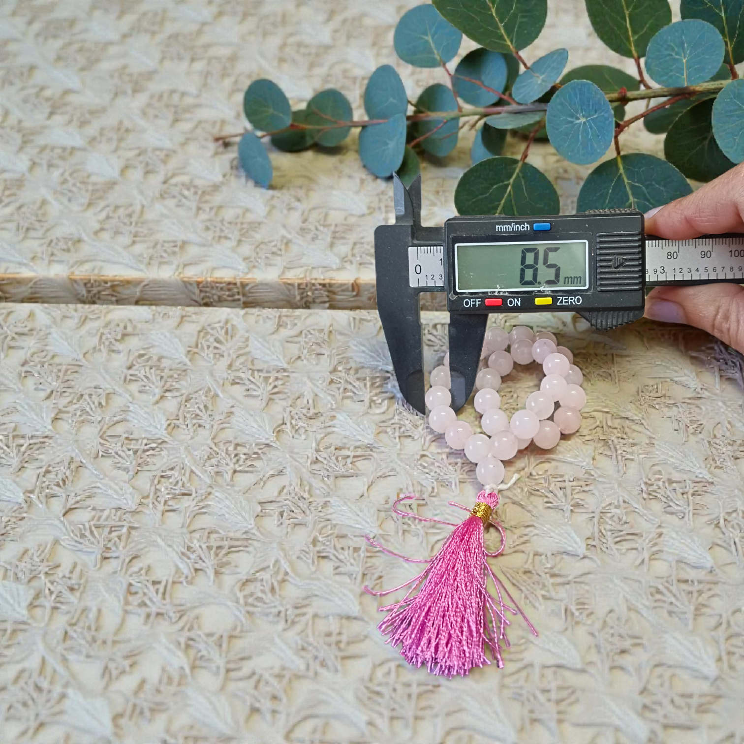 Natural Rose Quartz Mala with 8mm pink beads arranged neatly for meditation and spiritual use