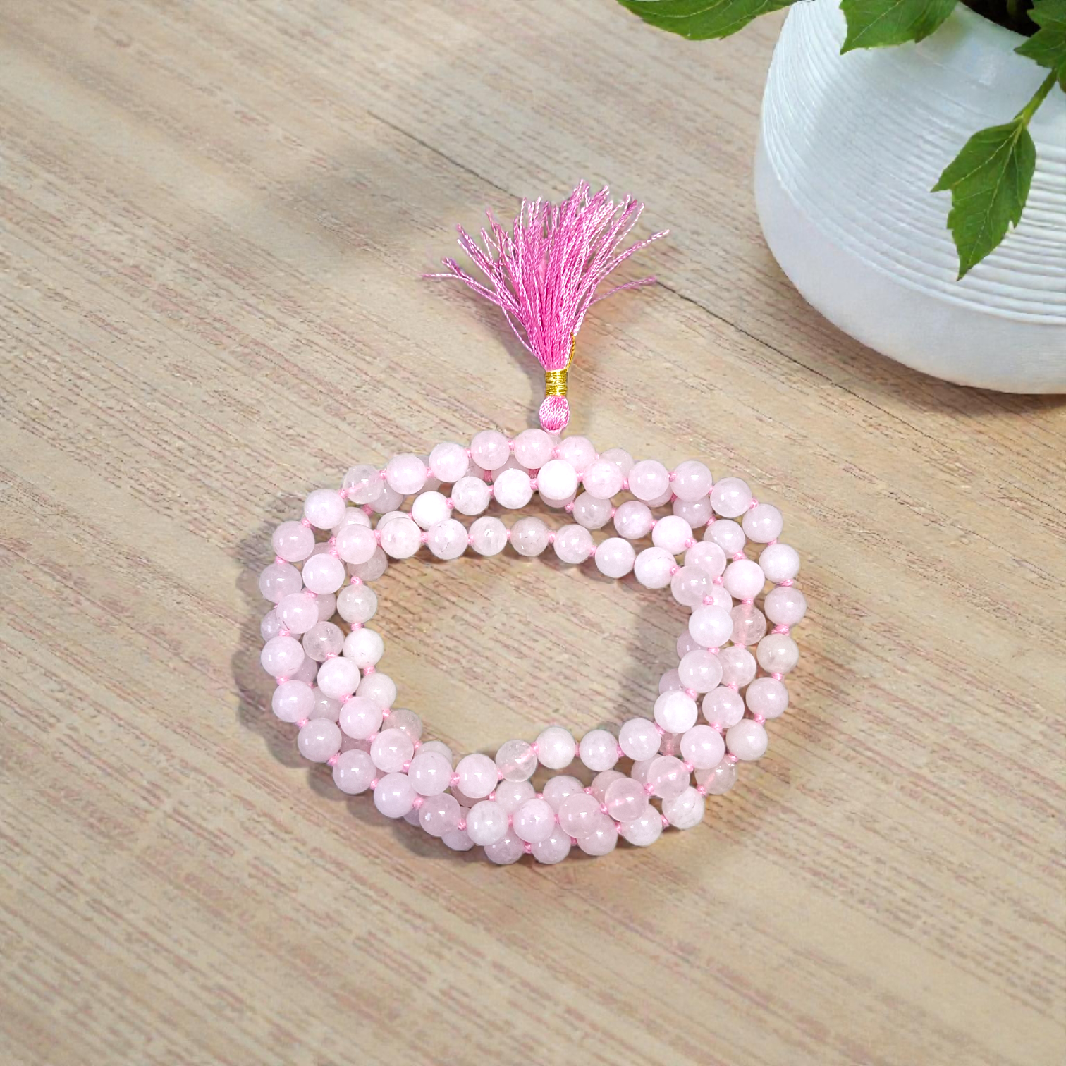 Natural Rose Quartz Mala with 8mm pink beads arranged neatly for meditation and spiritual use