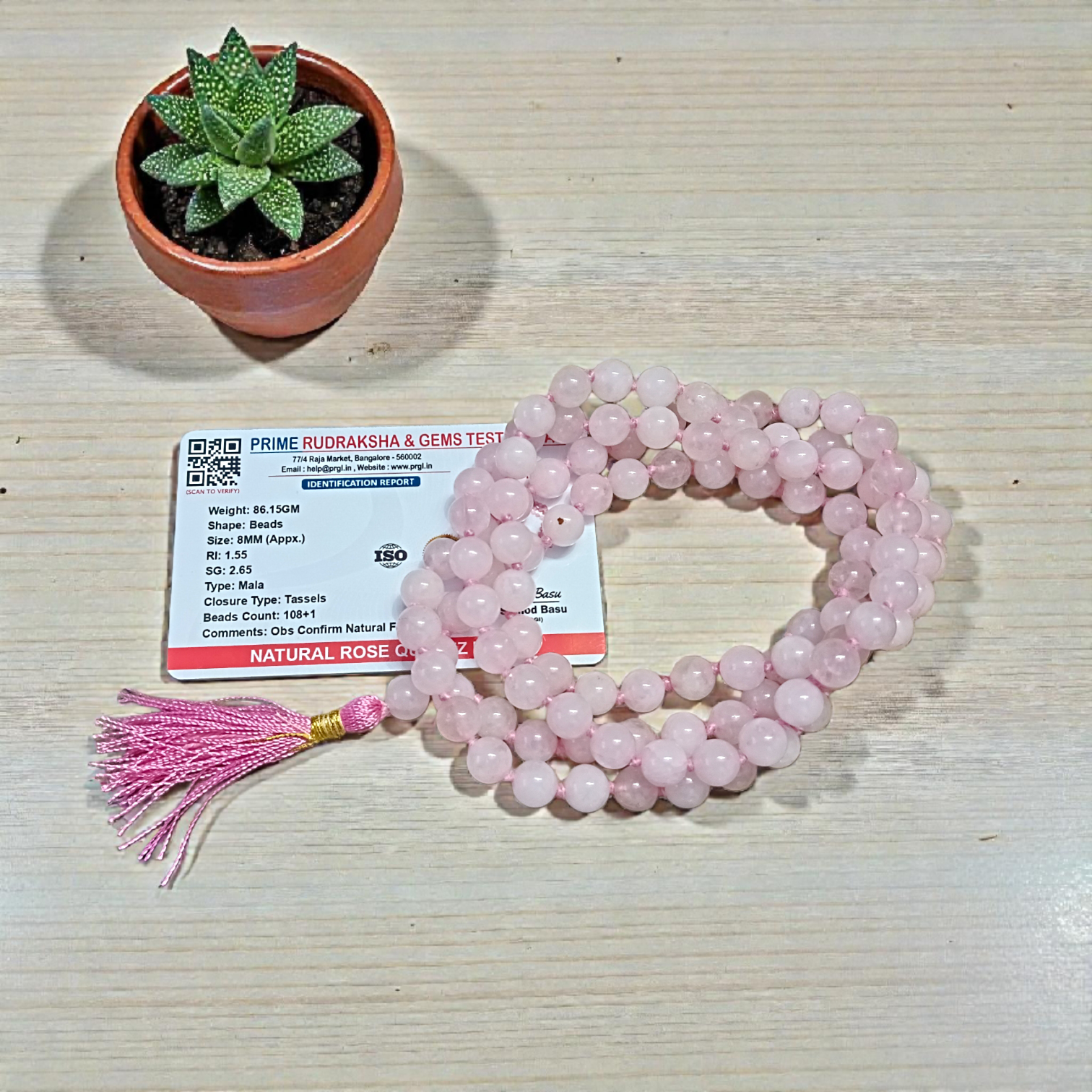 Natural Rose Quartz Mala with 8mm pink beads arranged neatly for meditation and spiritual use