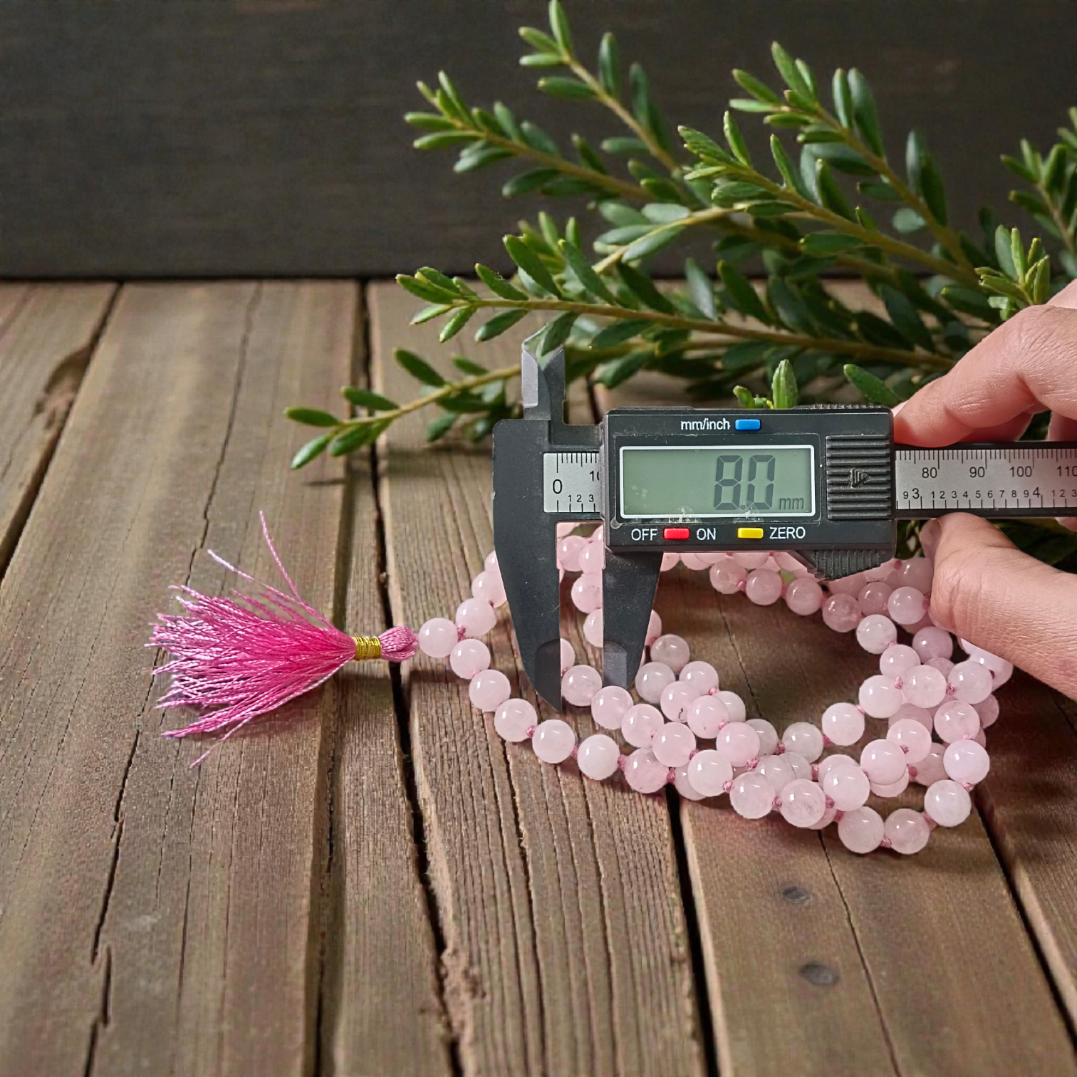 Natural Rose Quartz Mala with 8mm pink beads arranged neatly for meditation and spiritual use