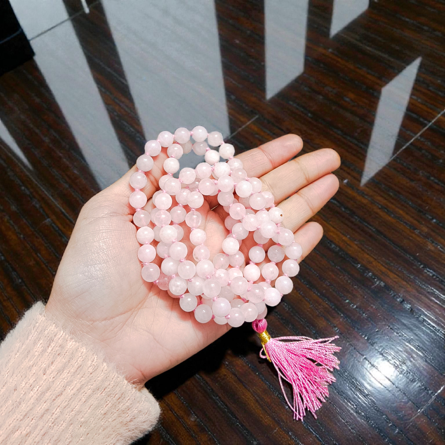 Natural Rose Quartz Mala with 8mm pink beads arranged neatly for meditation and spiritual use