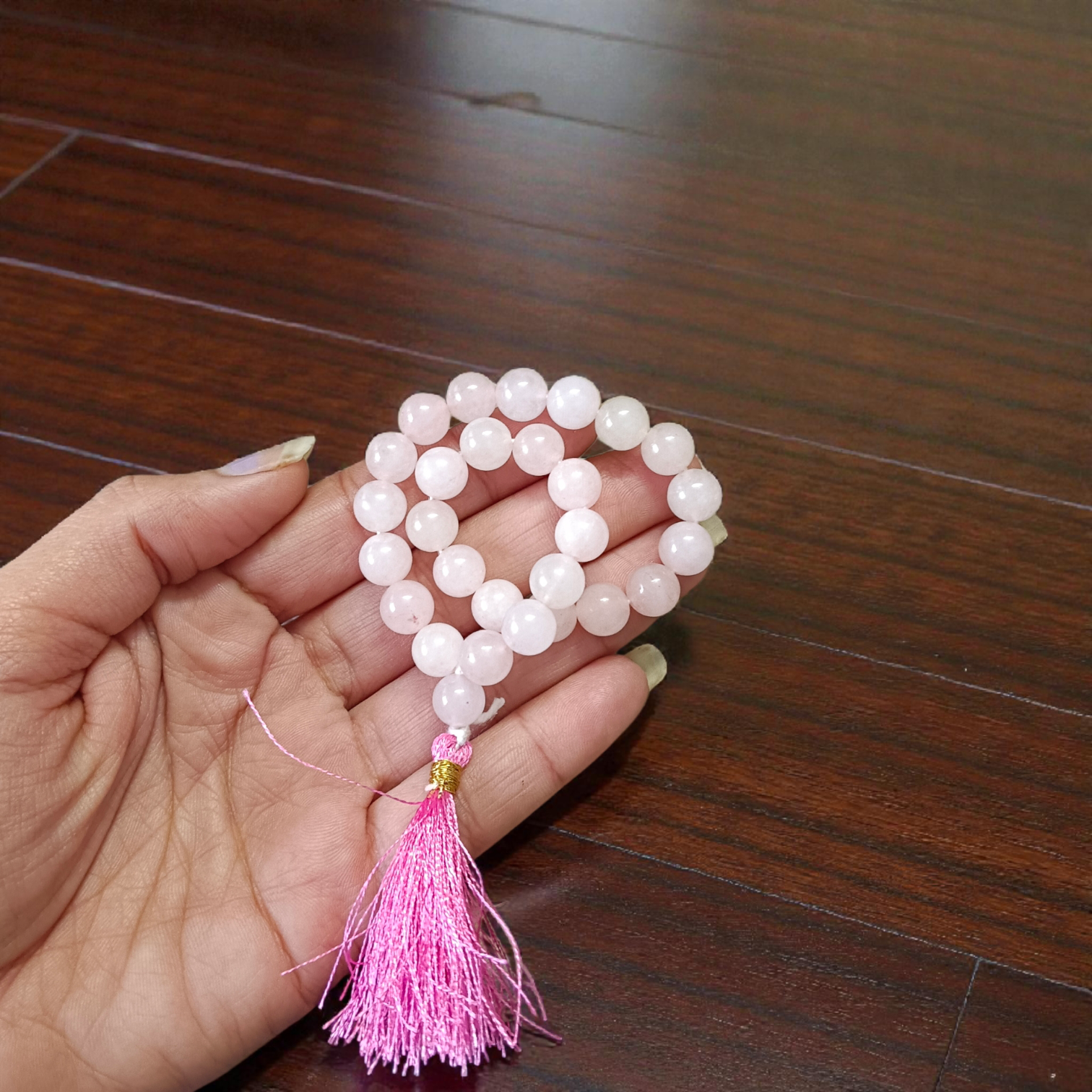 Natural Rose Quartz Mala with 8mm pink beads arranged neatly for meditation and spiritual use