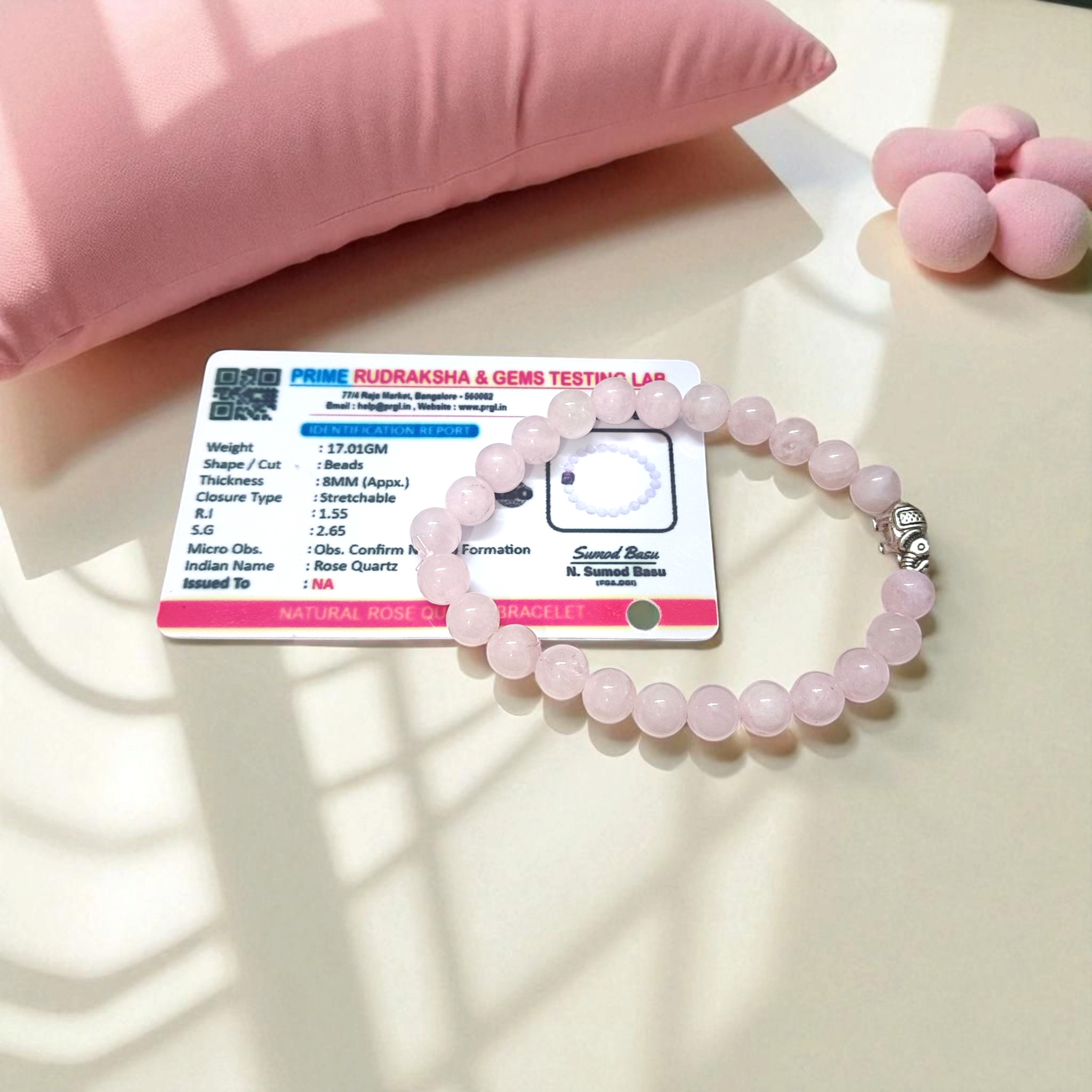Natural Rose Quartz bracelet with 8mm round pink beads on a stretchable band, displayed on a clean white background