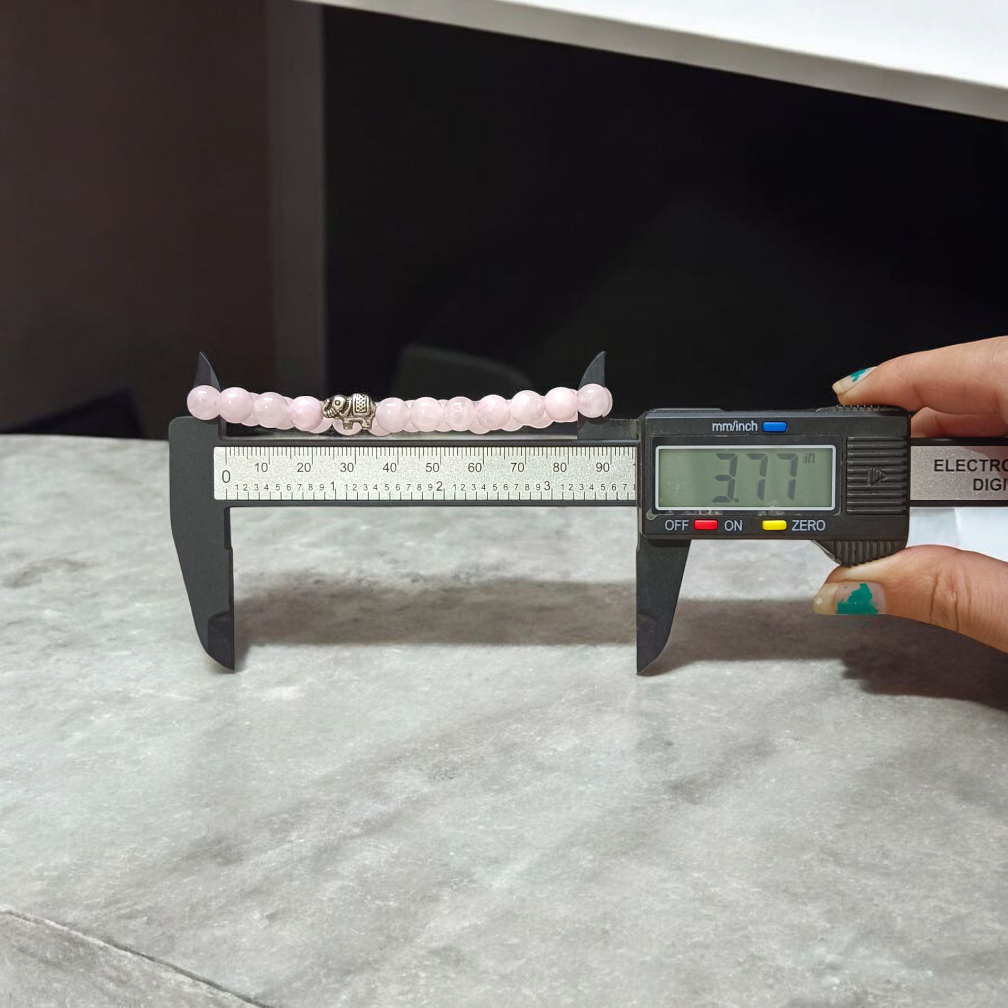 Natural Rose Quartz bracelet with 8mm round pink beads on a stretchable band, displayed on a clean white background