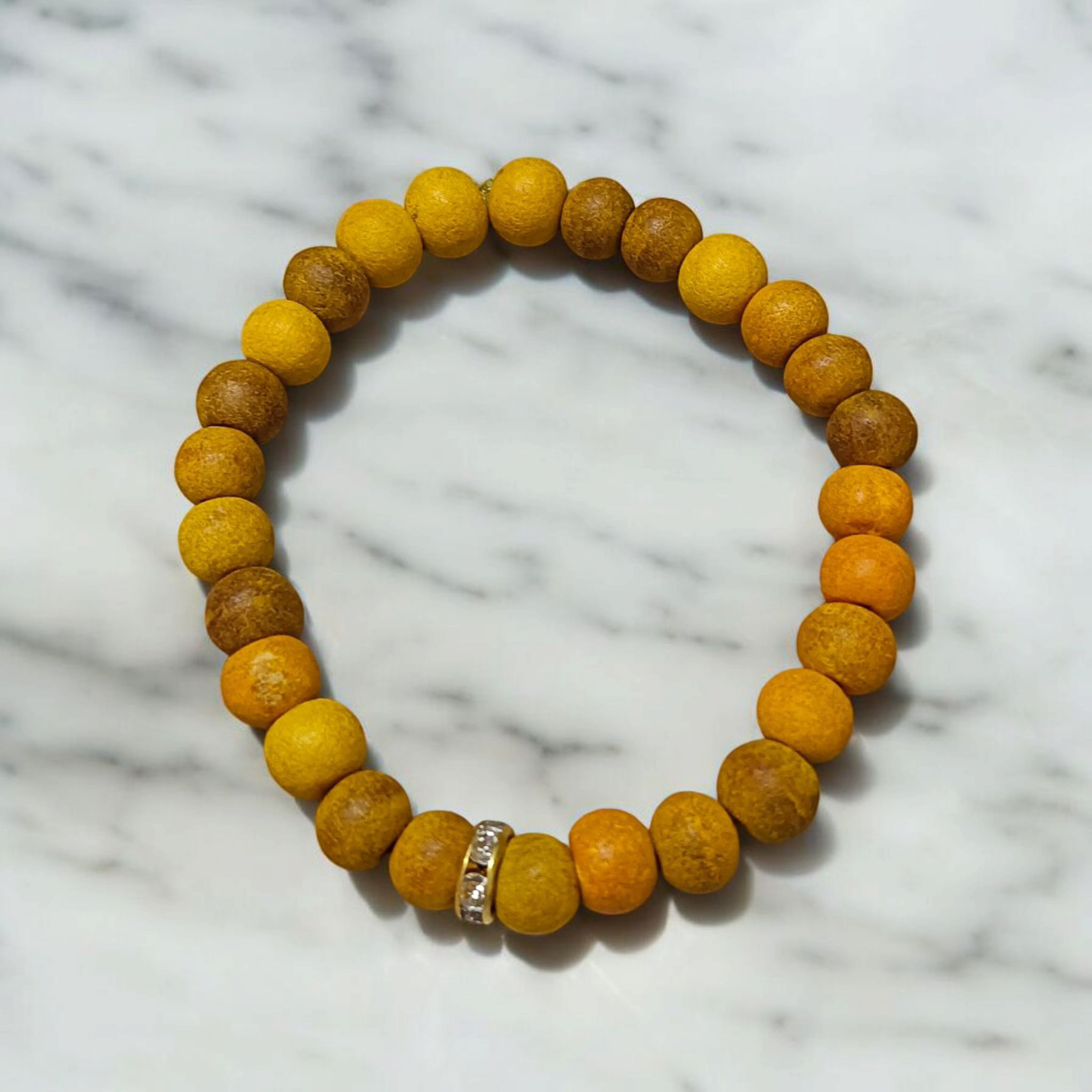 Natural Turmeric (Haldi) Bracelet with 7mm yellow beads, stretchable and handcrafted, displayed on a neutral background for men and women