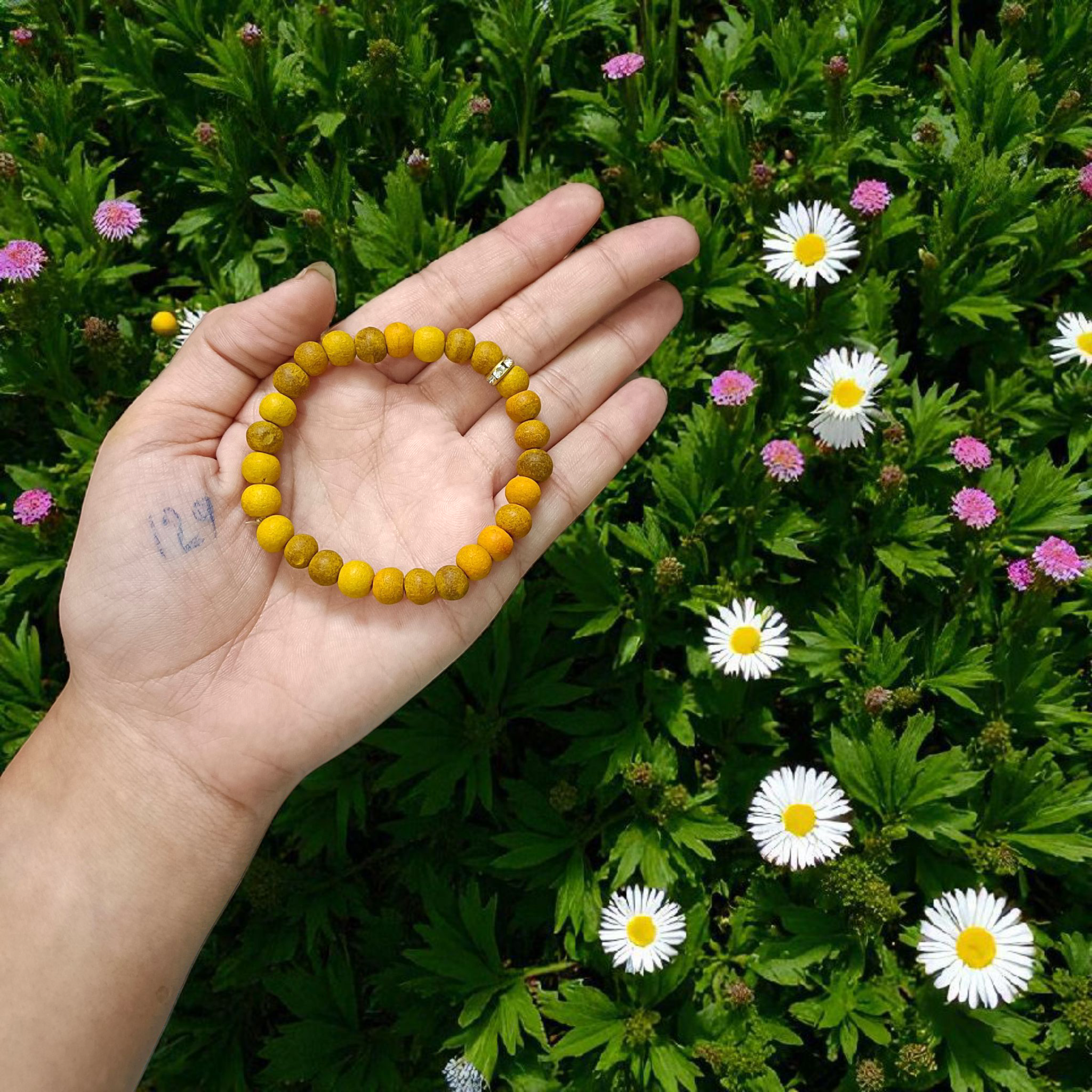 Natural Turmeric (Haldi) Bracelet with 7mm yellow beads, stretchable and handcrafted, displayed on a neutral background for men and women