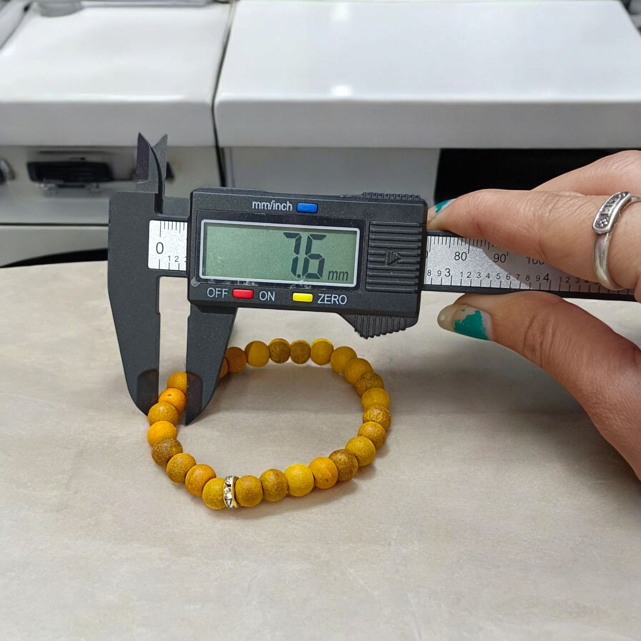 Natural Turmeric (Haldi) Bracelet with 7mm yellow beads, stretchable and handcrafted, displayed on a neutral background for men and women