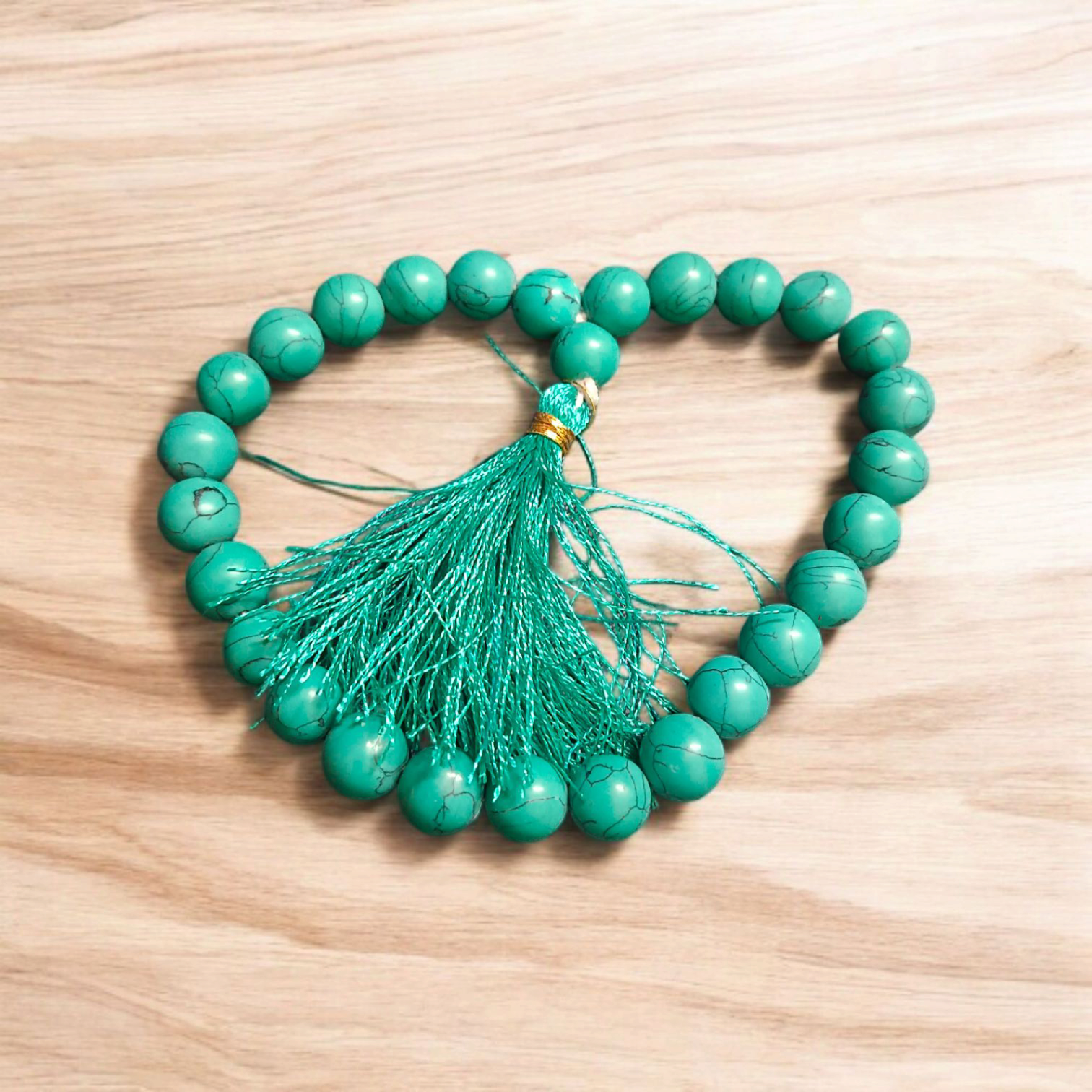 Natural Turquoise Mala with 8mm beads laid out on a wooden surface, showing two variants 27+1 and 108+1 beads.