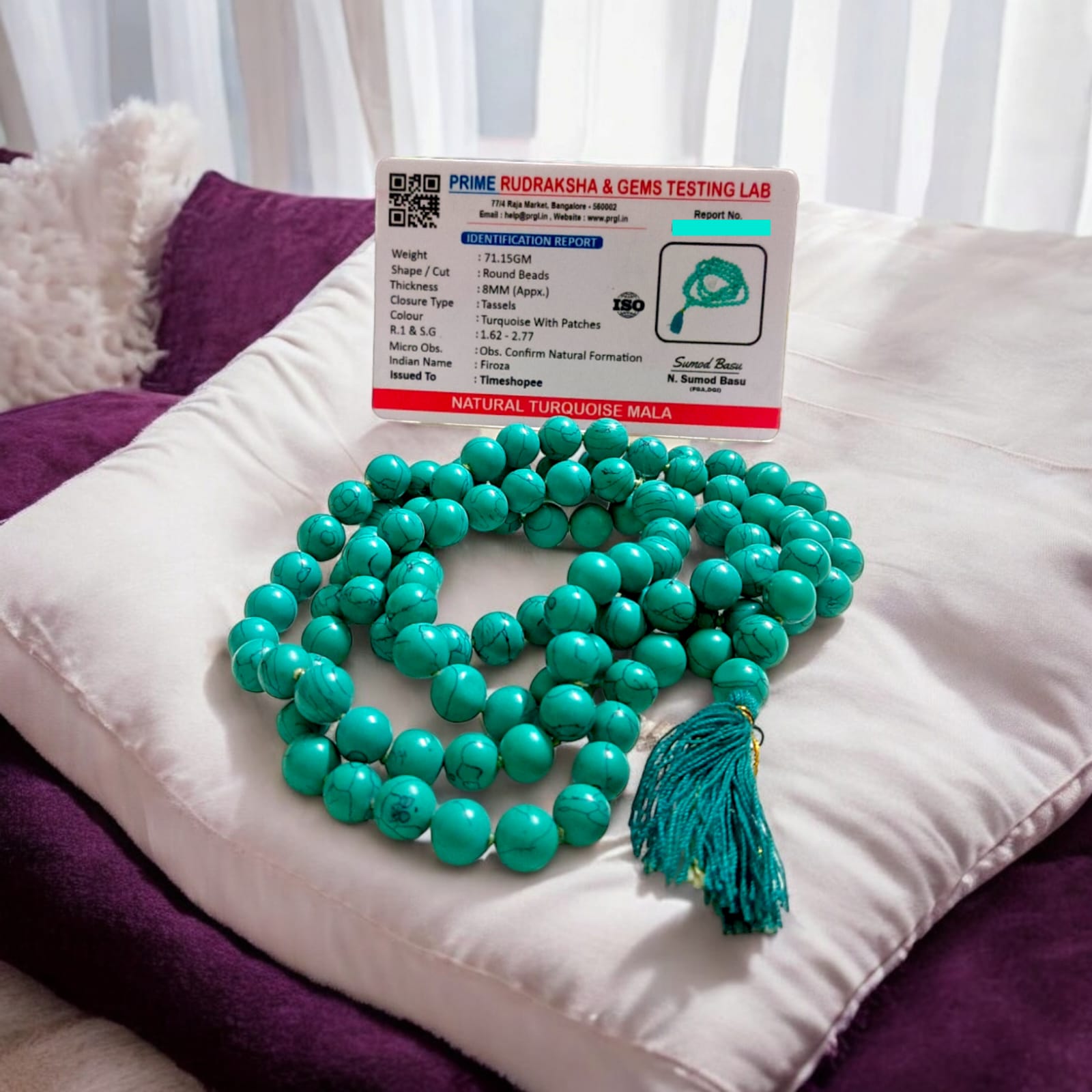 Natural Turquoise Mala with 8mm beads laid out on a wooden surface, showing two variants 27+1 and 108+1 beads.