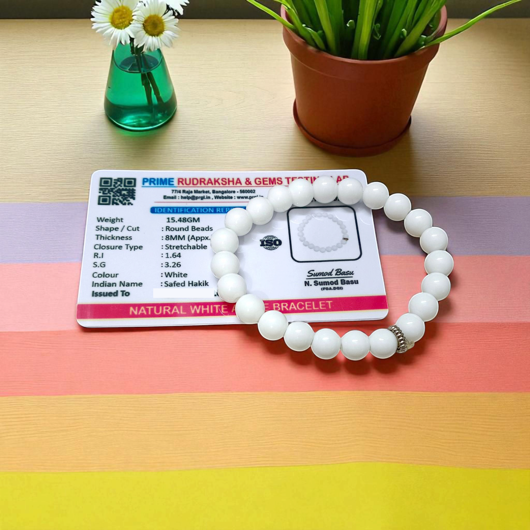 Natural White Agate bracelet with polished 8mm beads on a stretchable cord, displayed on a plain white background