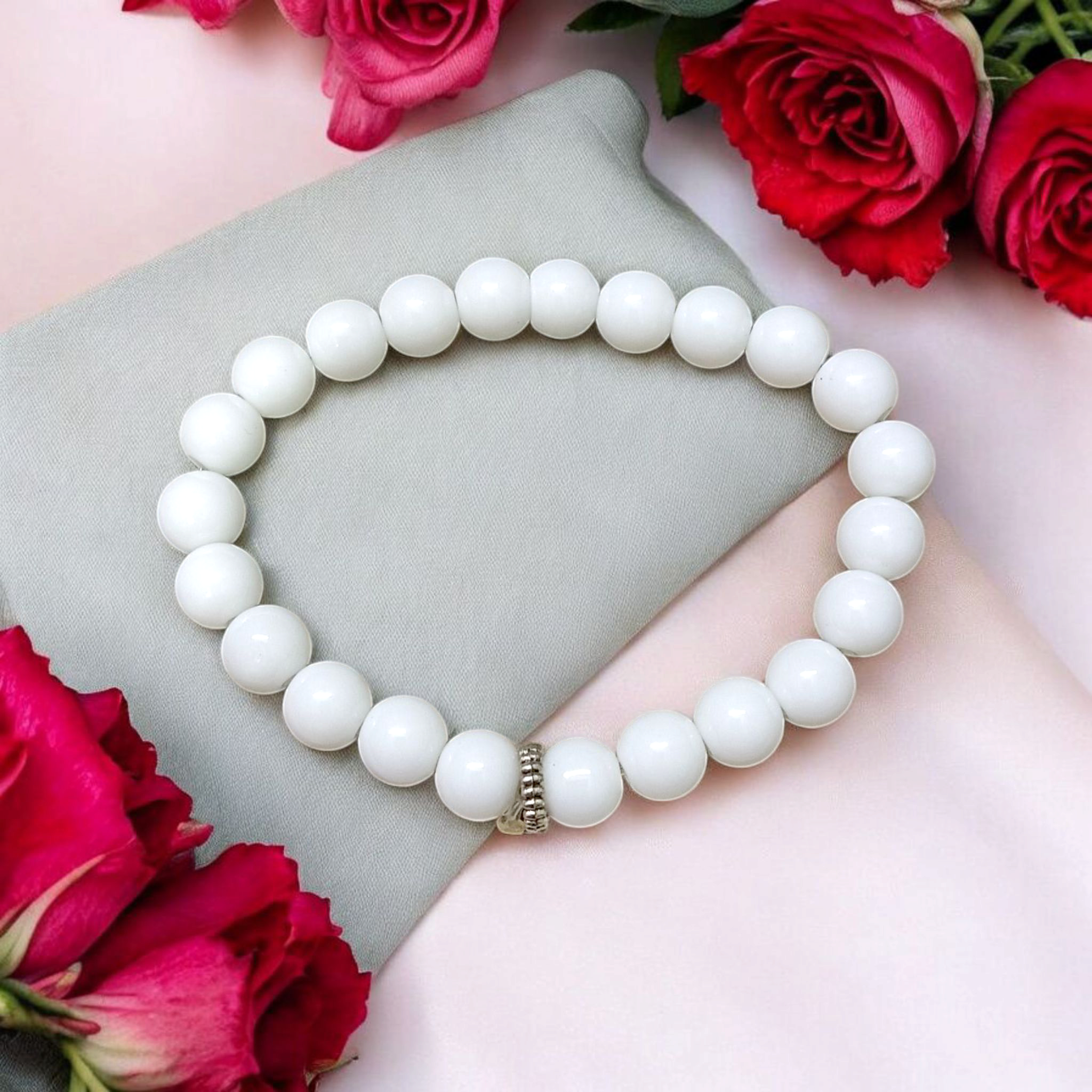 Natural White Agate bracelet with polished 8mm beads on a stretchable cord, displayed on a plain white background