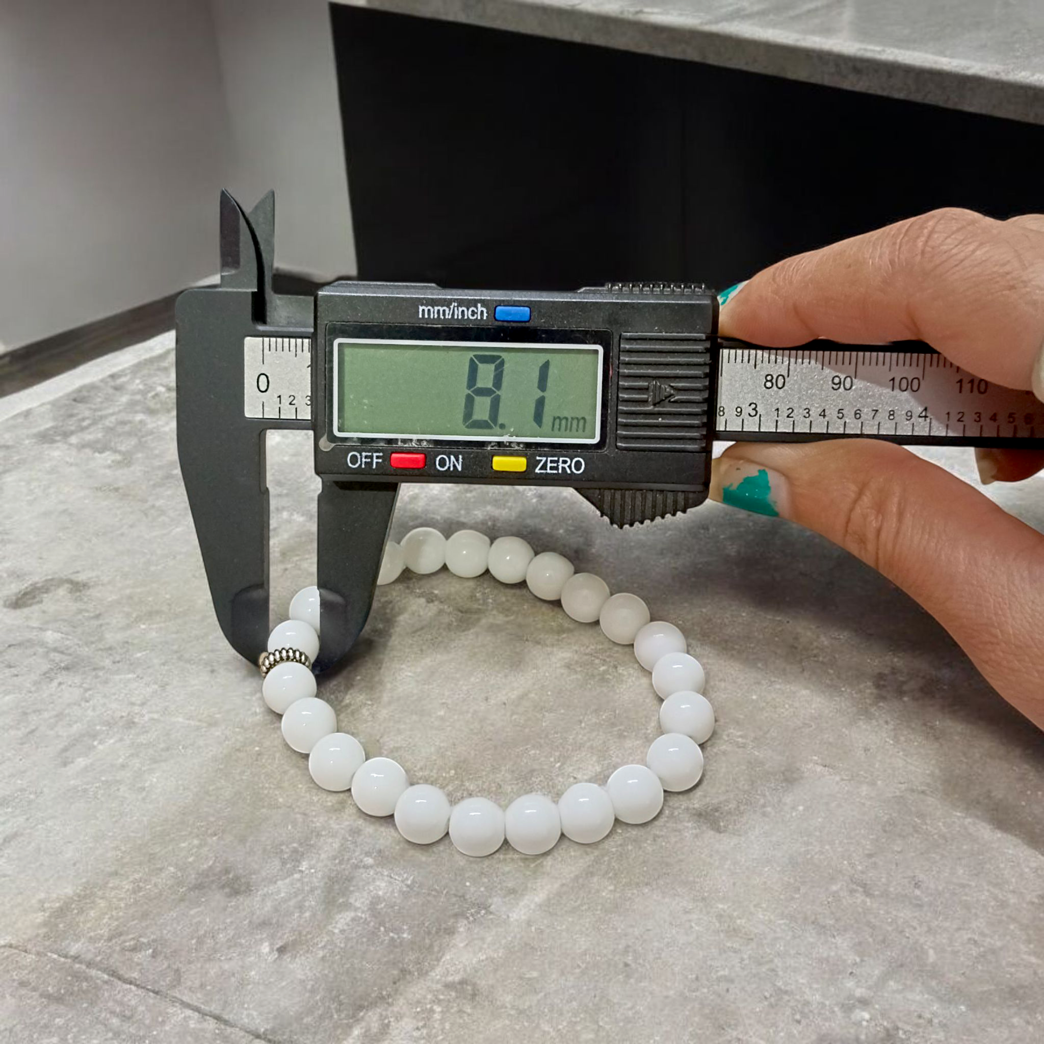 Natural White Agate bracelet with polished 8mm beads on a stretchable cord, displayed on a plain white background