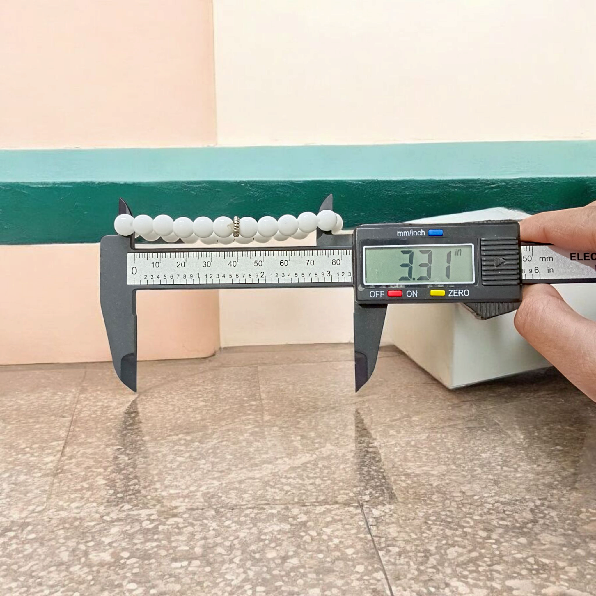 Natural White Agate bracelet with polished 8mm beads on a stretchable cord, displayed on a plain white background