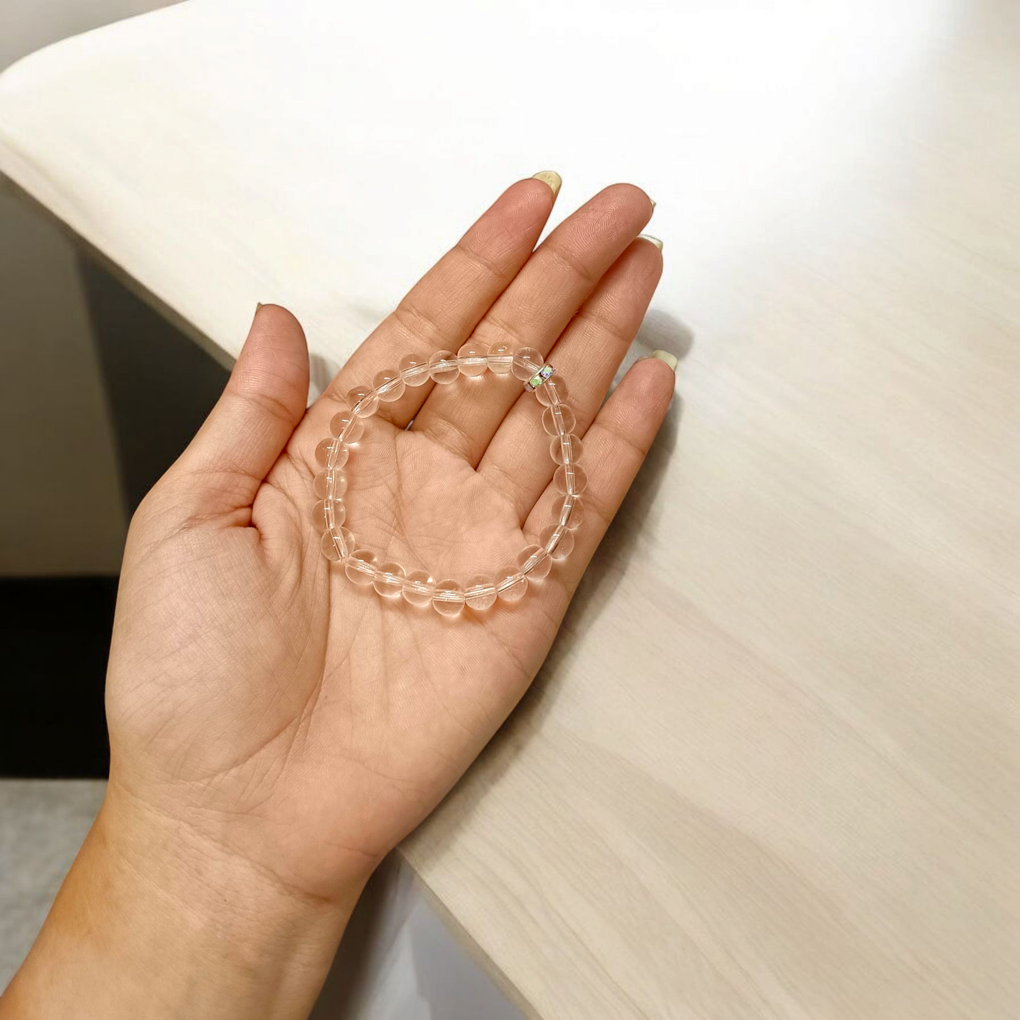 Natural crystal bracelet made of 7mm beads with stretchable string, unisex design, displayed on a neutral background