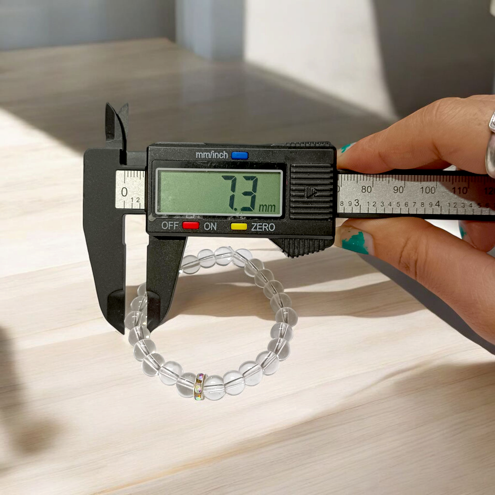 Natural crystal bracelet made of 7mm beads with stretchable string, unisex design, displayed on a neutral background