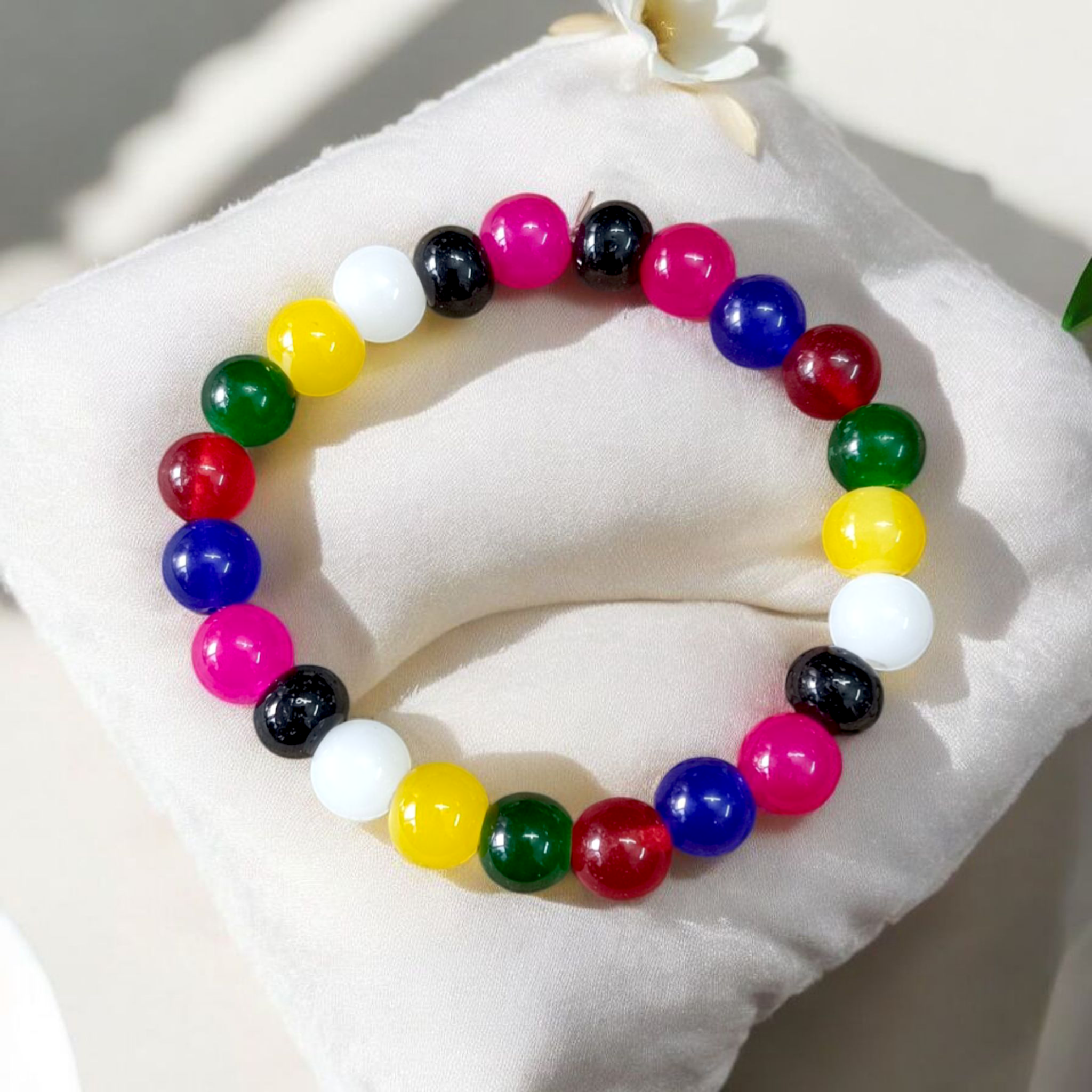 Natural multicolor agate (Hakik) bracelet made with 8mm round beads on a stretchable string, displayed on a neutral background