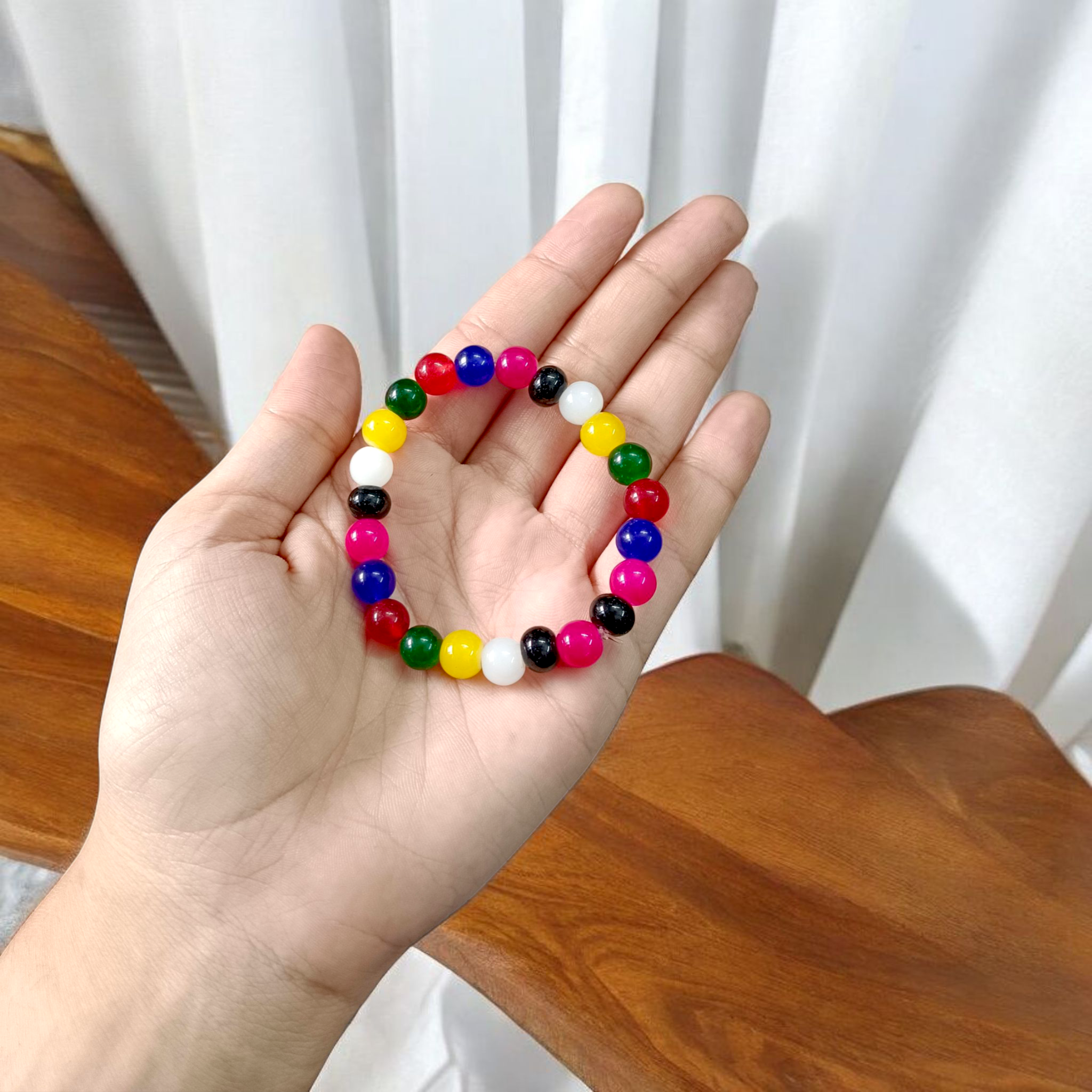 Natural multicolor agate (Hakik) bracelet made with 8mm round beads on a stretchable string, displayed on a neutral background