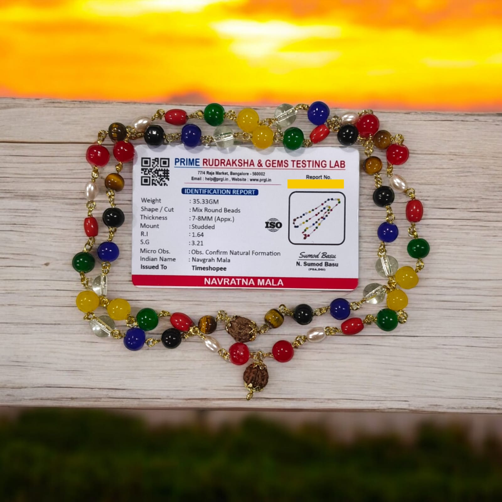 Navratna Mala with Rudraksh beads, featuring lab-certified gemstones for astrological balance and spiritual enhancement.