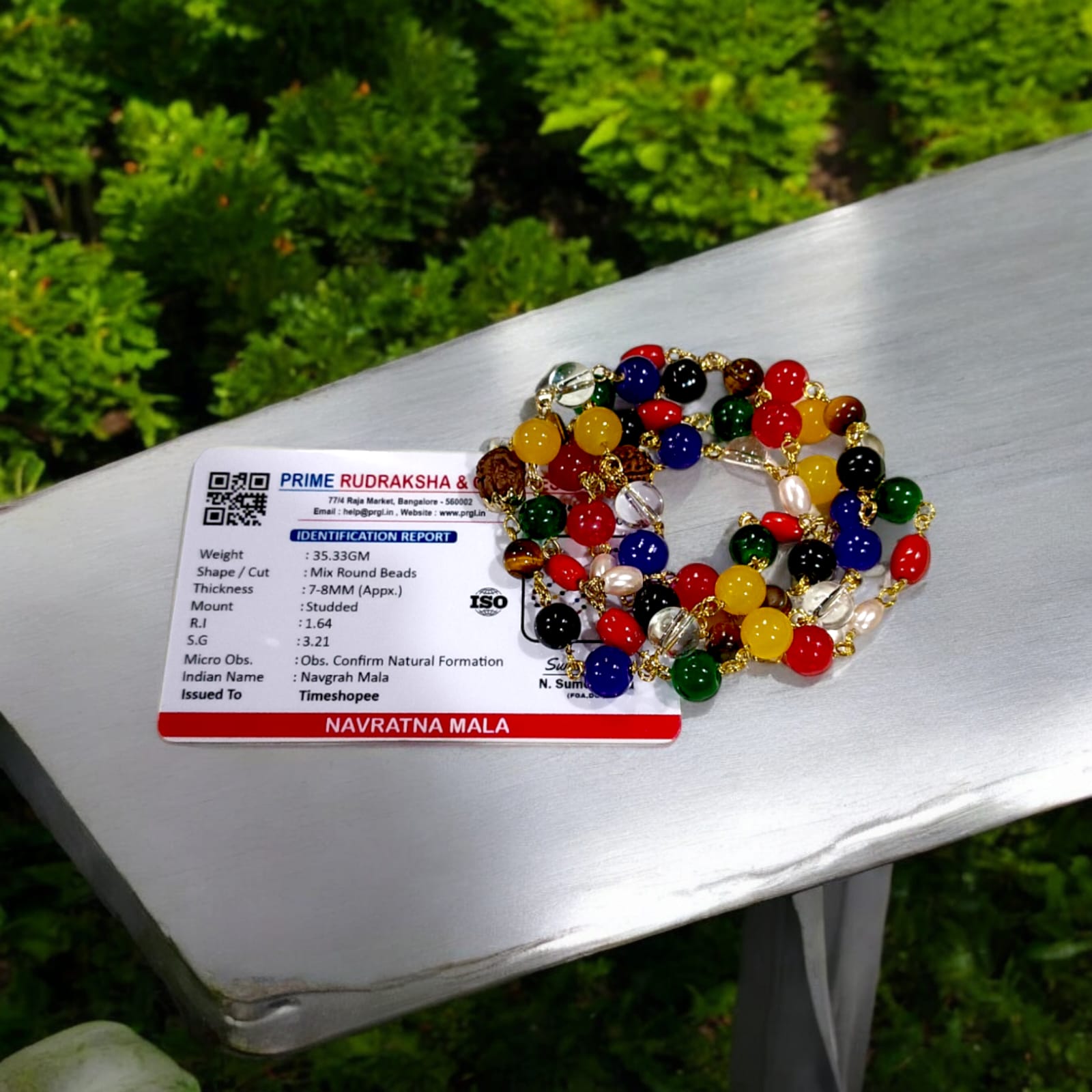 Navratna Mala with Rudraksh beads, featuring lab-certified gemstones for astrological balance and spiritual enhancement.