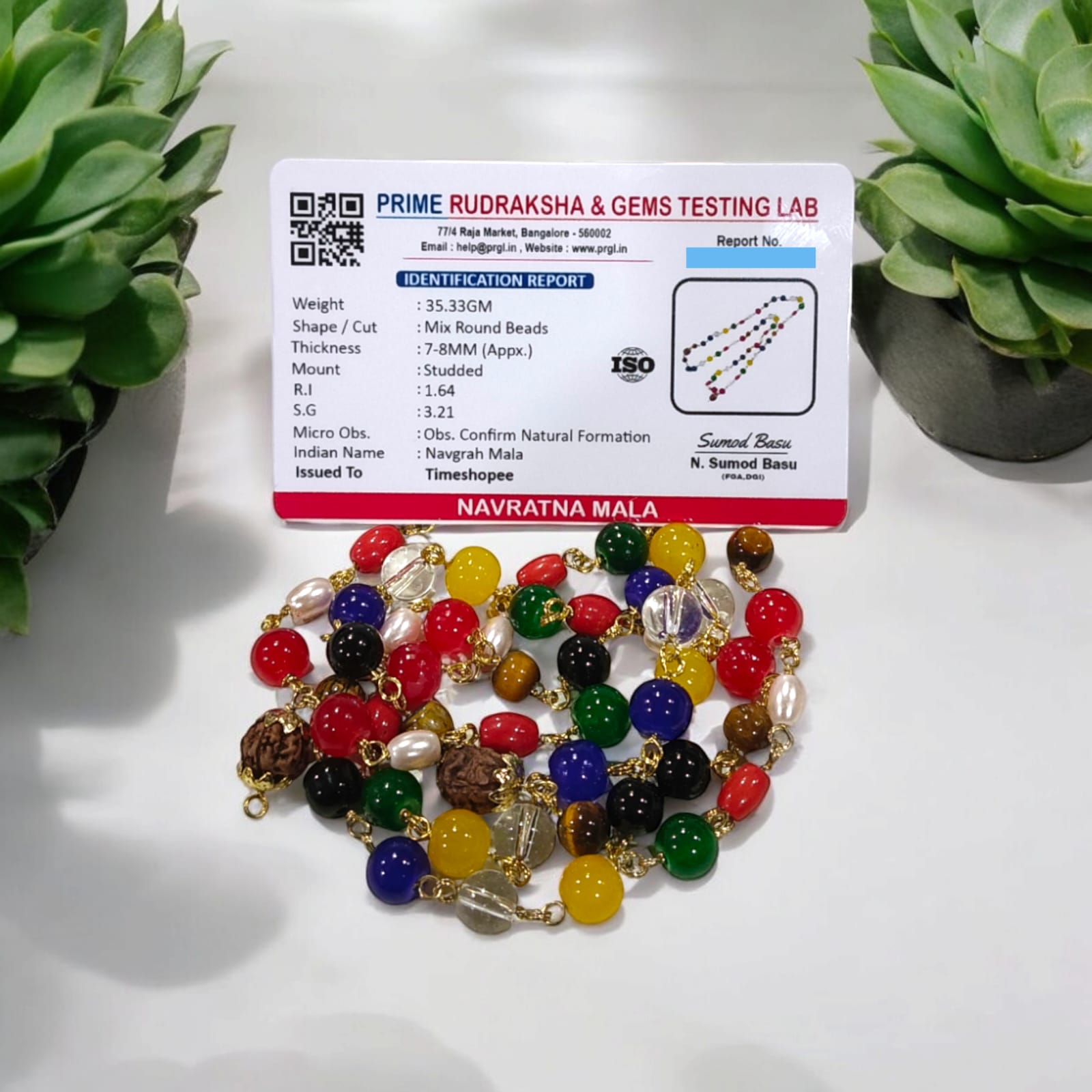 Navratna Mala with Rudraksh beads, featuring lab-certified gemstones for astrological balance and spiritual enhancement.