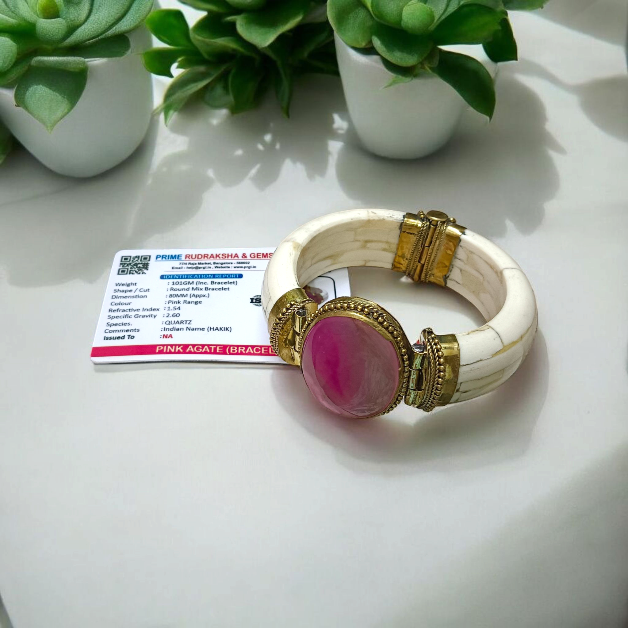 Pink Agate Bracelet with natural, lab-certified pink hakik stones, handcrafted in an antique finish, placed on a soft, feminine background