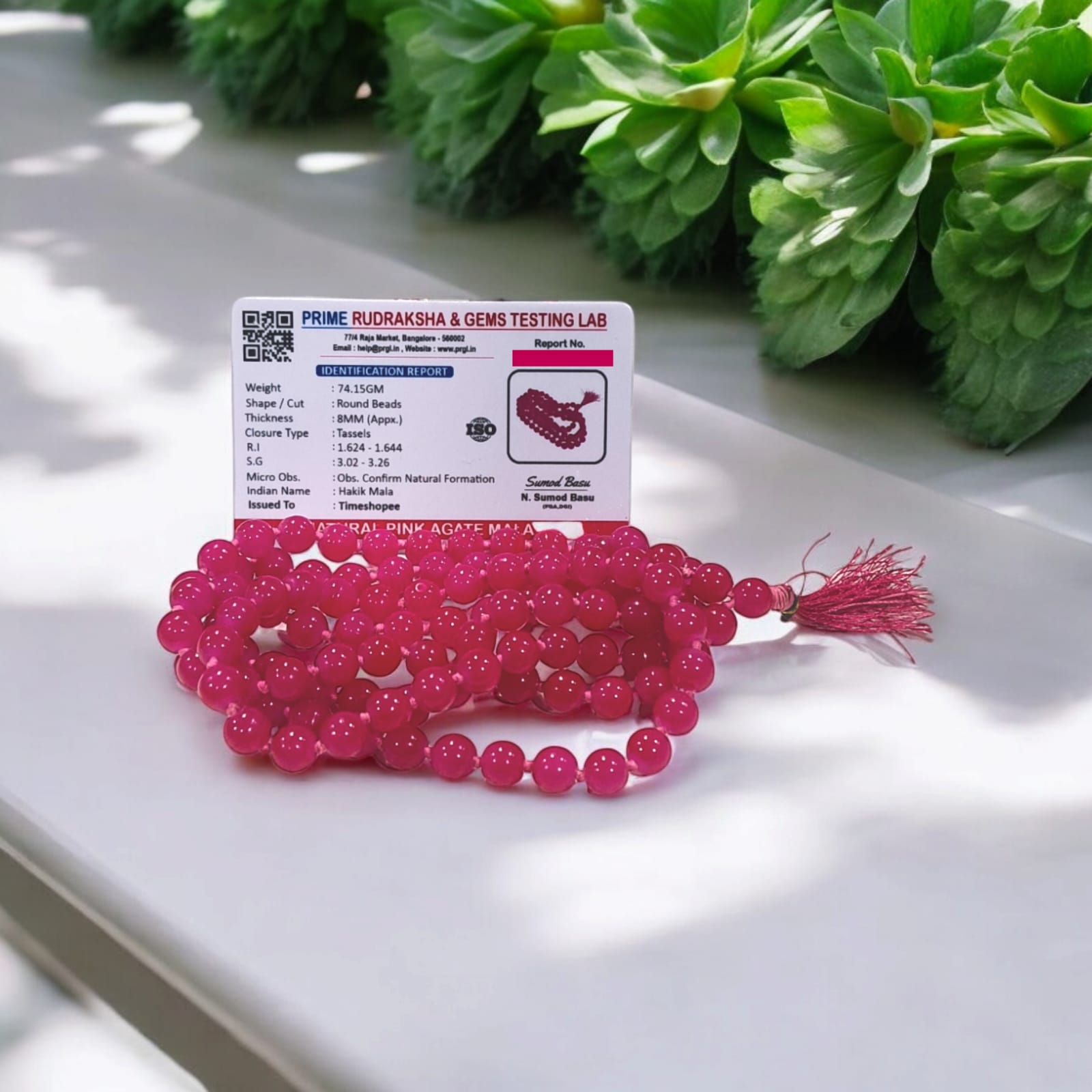 Pink Agate Mala with 8MM beads and 108+1 bead count, lab-certified for authenticity, displayed in a close-up view showing its delicate pink hues.