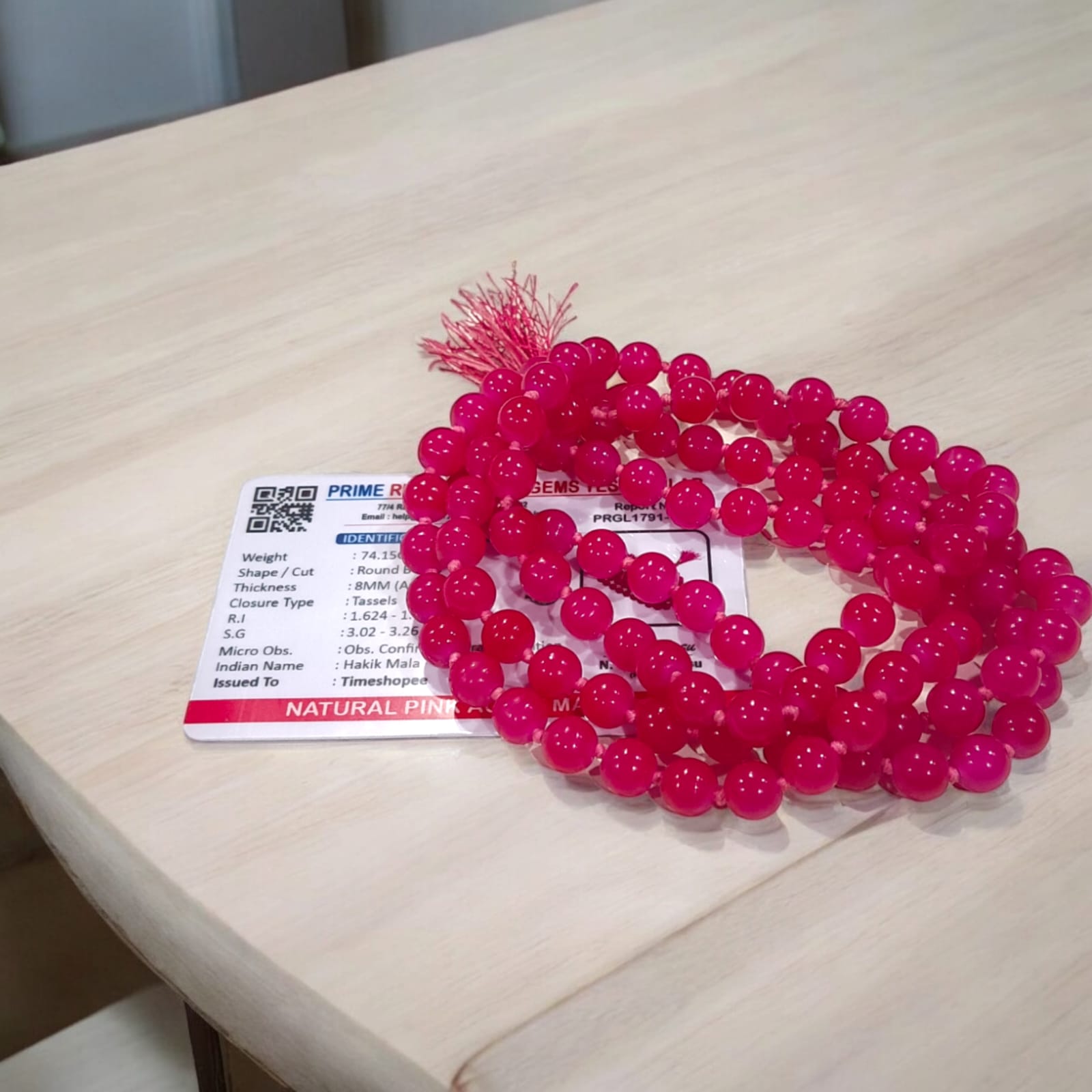 Pink Agate Mala with 8MM beads and 108+1 bead count, lab-certified for authenticity, displayed in a close-up view showing its delicate pink hues.