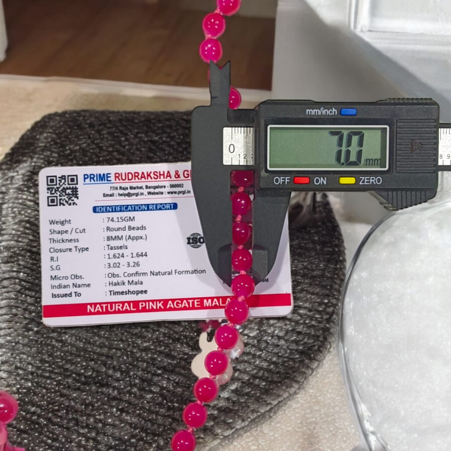 Pink Agate Mala with 8MM beads and 108+1 bead count, lab-certified for authenticity, displayed in a close-up view showing its delicate pink hues.