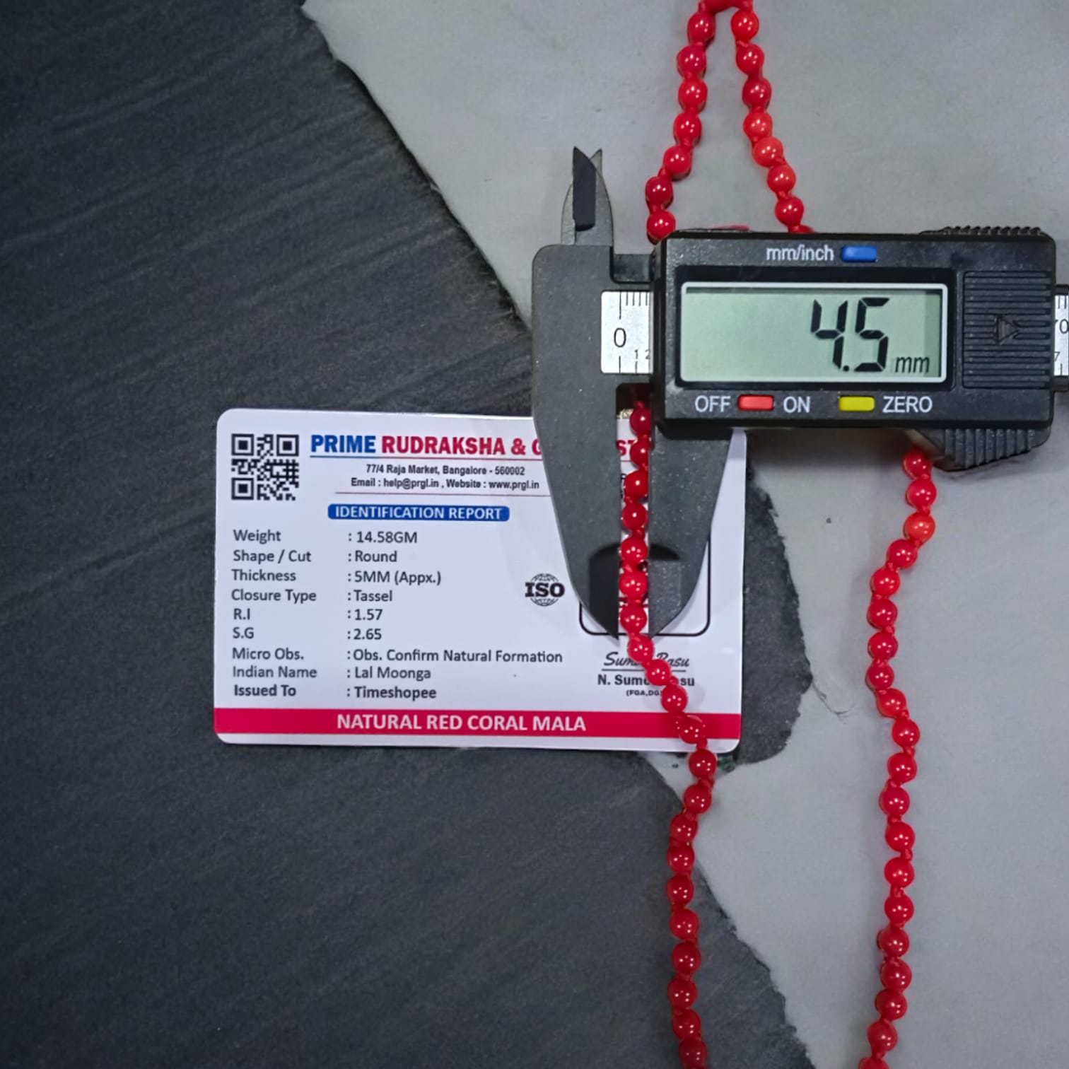 Red Coral Mala with 5MM beads and 108+1 bead count, lab-certified for authenticity, displayed in a close-up view showcasing its vibrant red color.