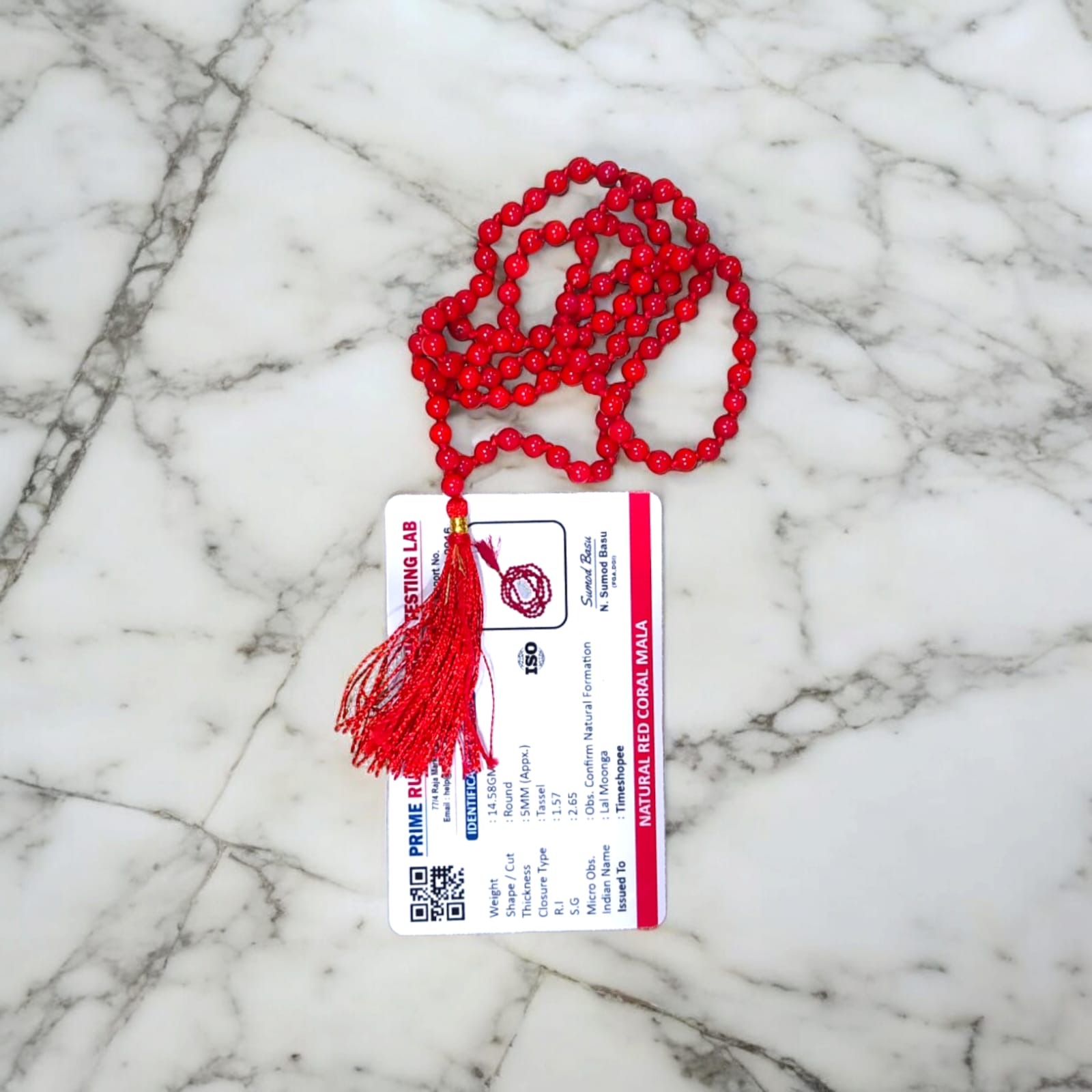 Red Coral Mala with 5MM beads and 108+1 bead count, lab-certified for authenticity, displayed in a close-up view showcasing its vibrant red color.
