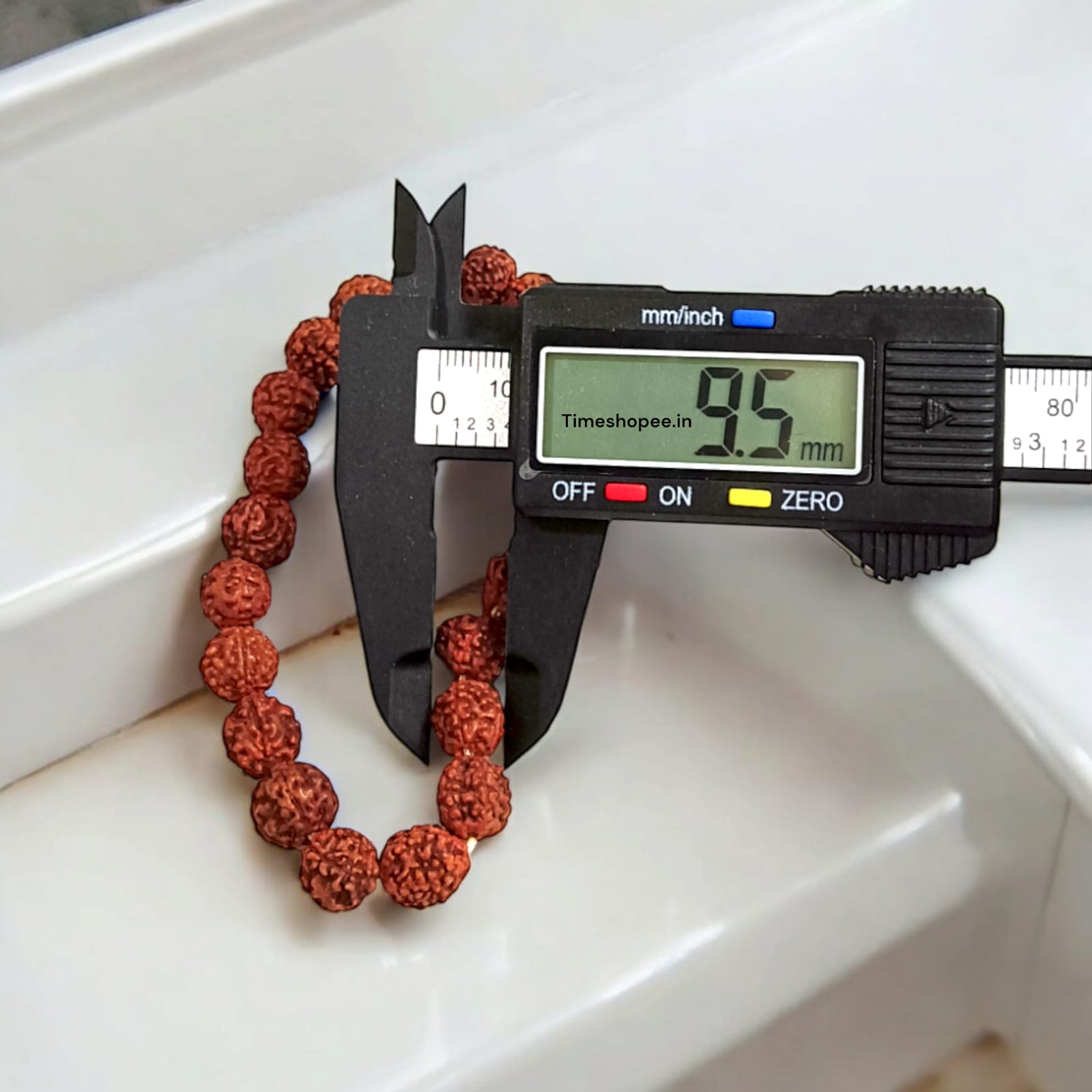 Rudraksha bracelet featuring 10MM beads, lab certified, displayed on a neutral background, highlighting its intricate design and quality certification.