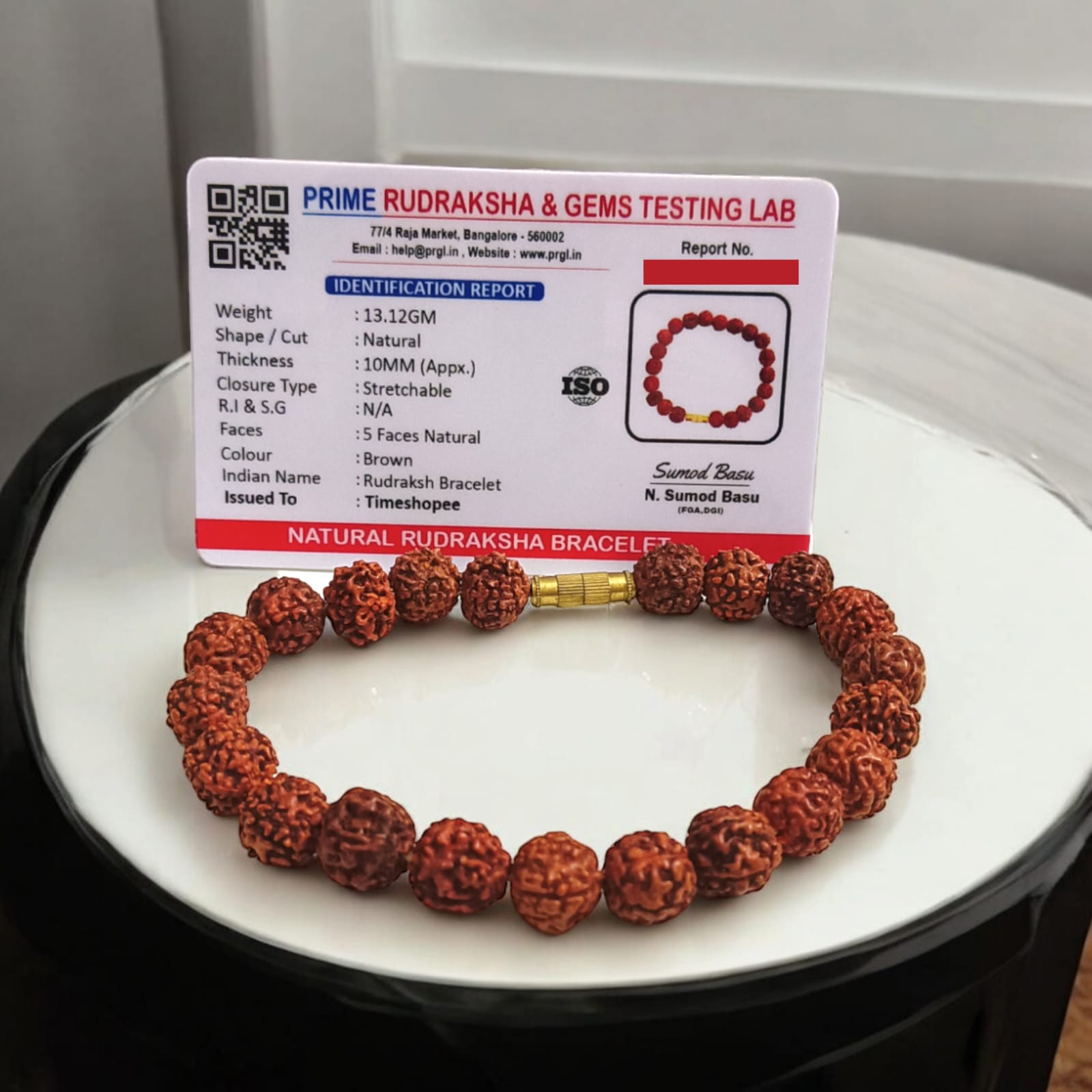 Rudraksha bracelet featuring 10MM beads, lab certified, displayed on a neutral background, highlighting its intricate design and quality certification.