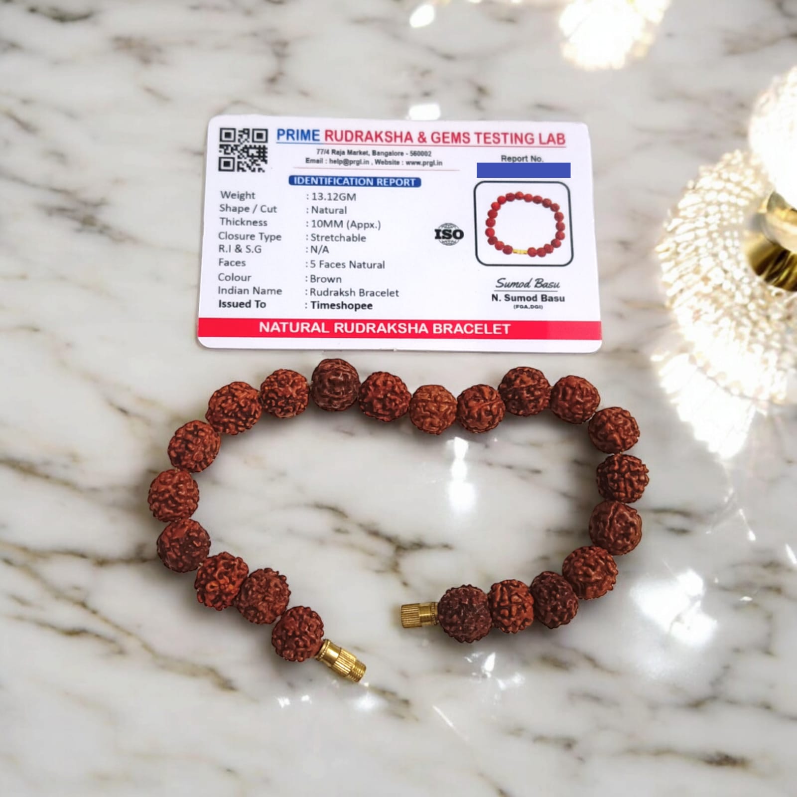 Rudraksha bracelet featuring 10MM beads, lab certified, displayed on a neutral background, highlighting its intricate design and quality certification.