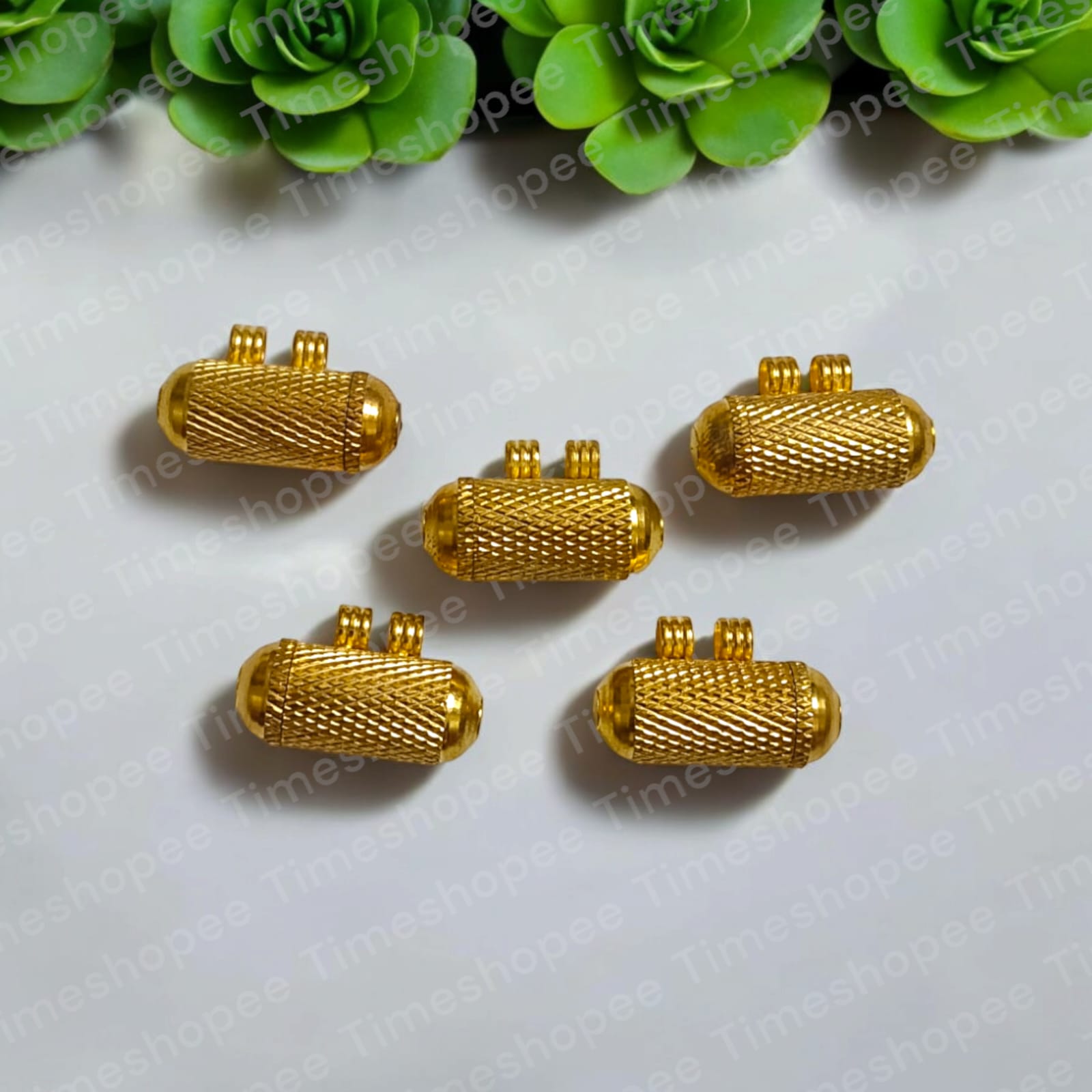 Set of Pure Golden metal taweezes with Bhojpatra sheet, displayed elegantly on a neutral background