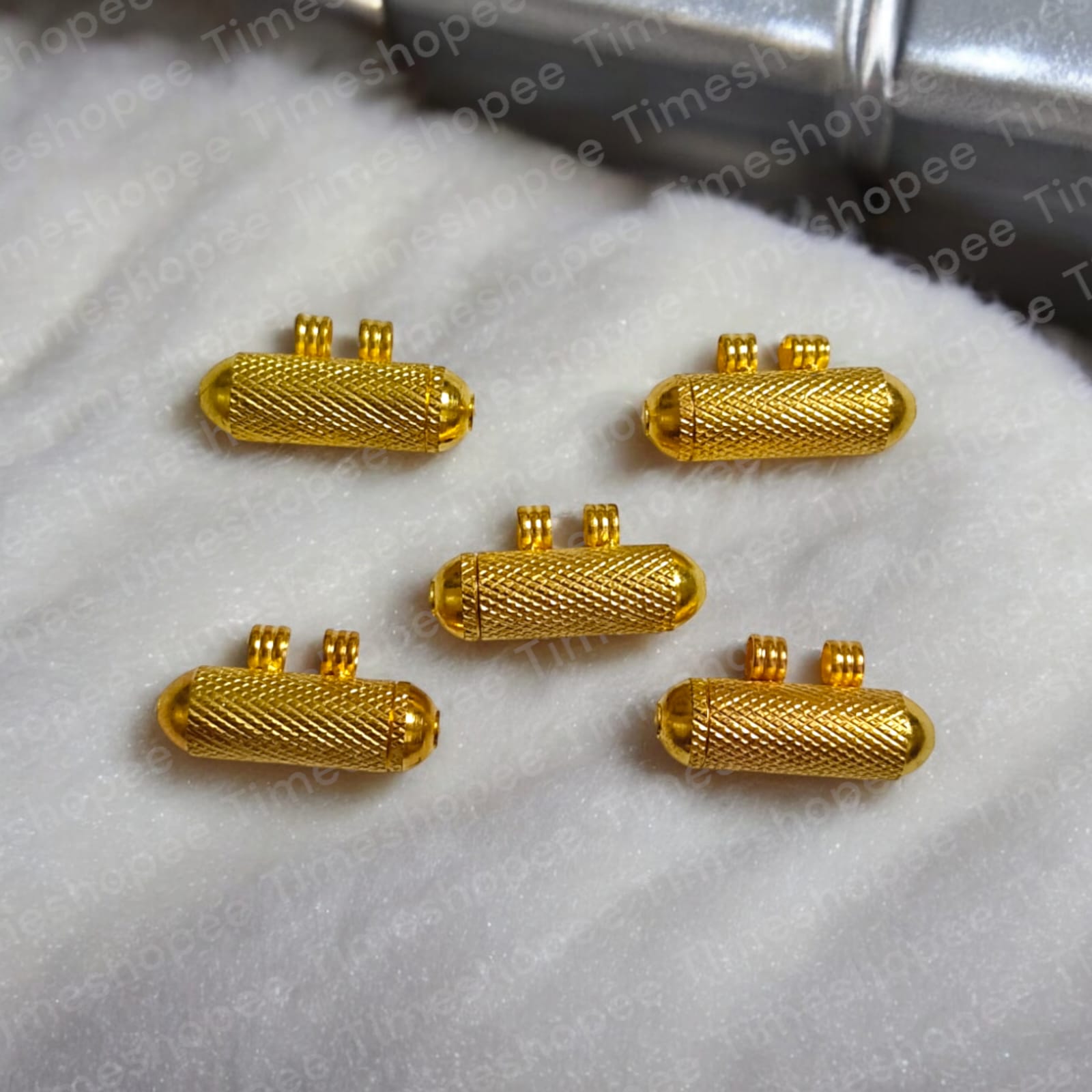 Set of Pure Golden metal taweezes with Bhojpatra sheet, displayed elegantly on a neutral background