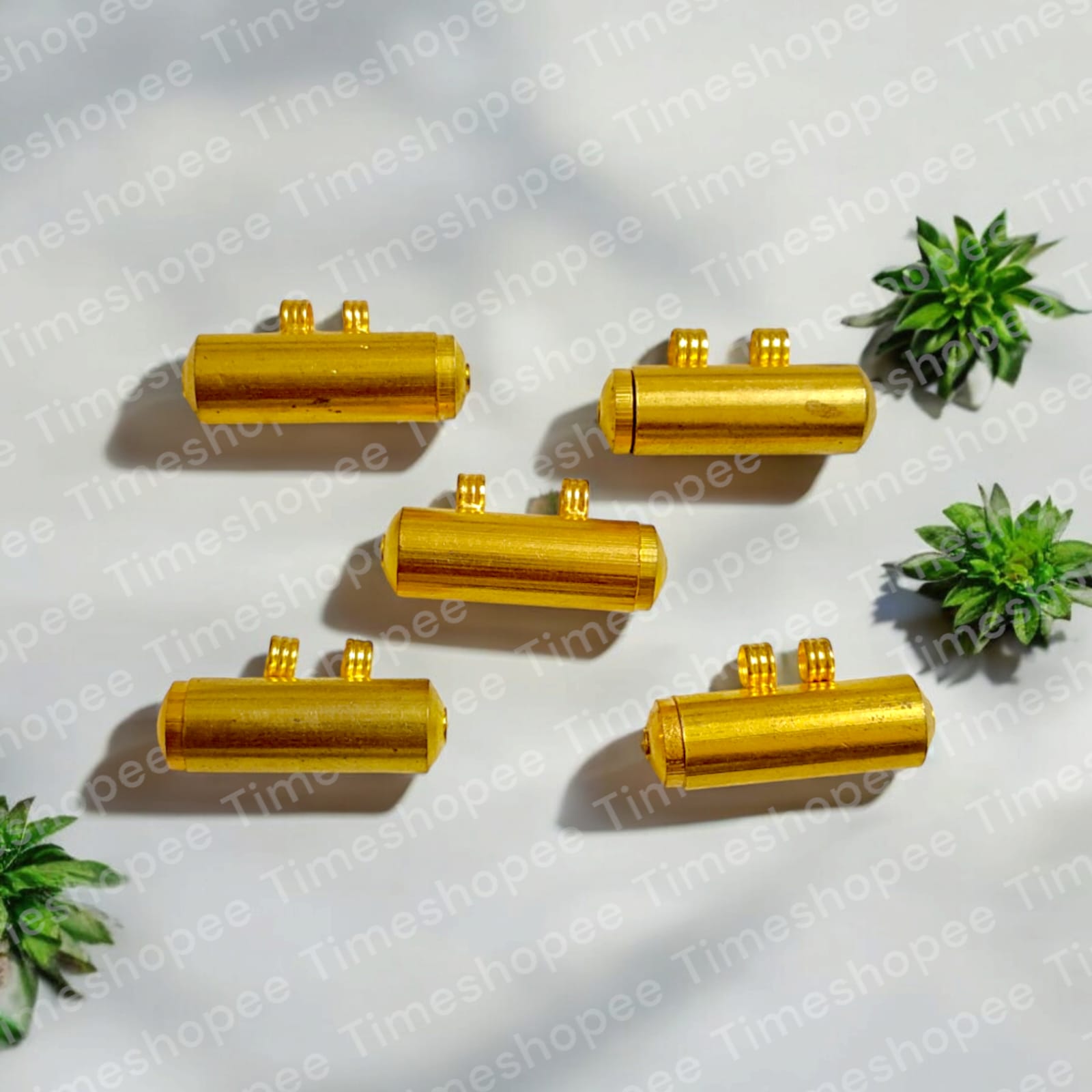 Set of five pure brass taweez amulets in golden color with a Bhojpatra sheet, highlighting their elegant design and spiritual purpose.