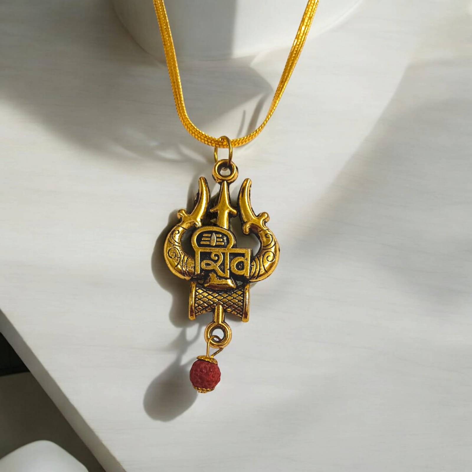 Shiv Locket with Rudraksha, featuring a Shiv Trishul and Damru pendant, gold-plated brass caps, and a free gold chain.