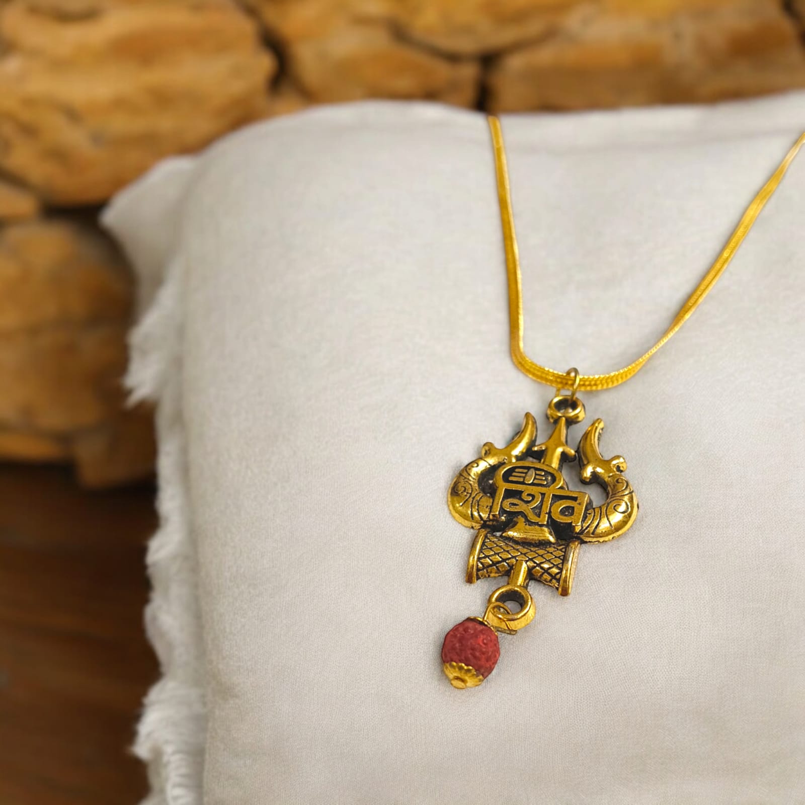 Shiv Locket with Rudraksha, featuring a Shiv Trishul and Damru pendant, gold-plated brass caps, and a free gold chain.
