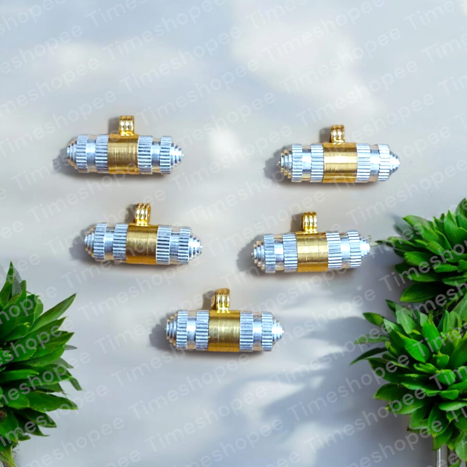 Silver and brass taweez amulets displayed with a Bhojpatra sheet, showcasing their elegant design and spiritual significance.