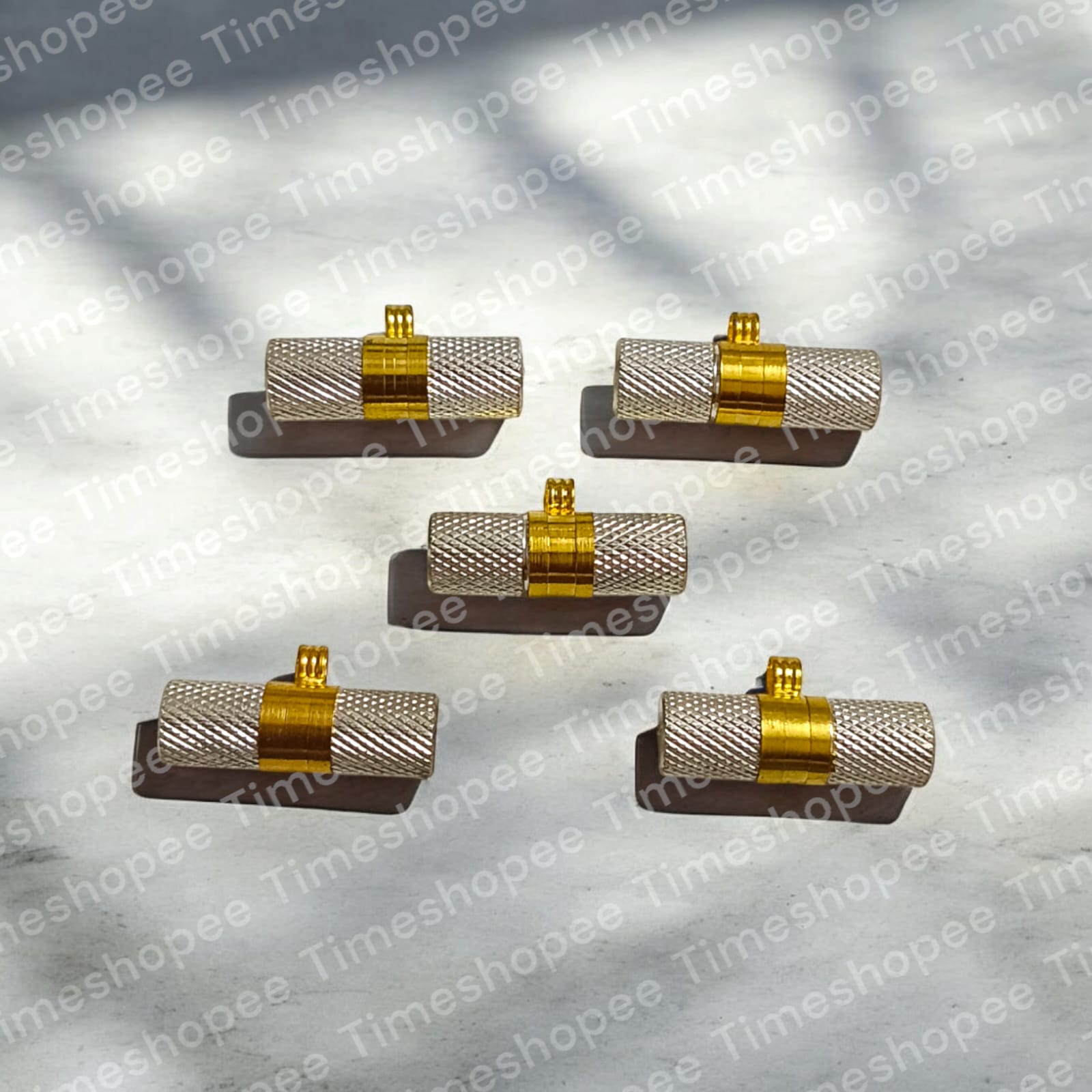 Silver and golden taweezes with Bhojpatra sheet, displayed on a neutral background